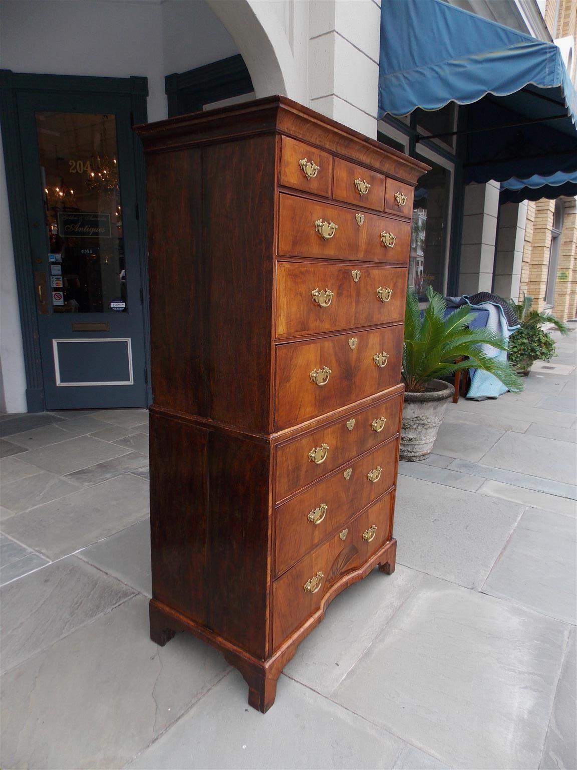 English Chippendale burl walnut chest on chest with a carved molded edge cornice, six graduated upper case drawers with hearing bone inlay, three graduated lower case drawers with hearing bone inlay, a recessed oval satinwood and ebony inlaid star,