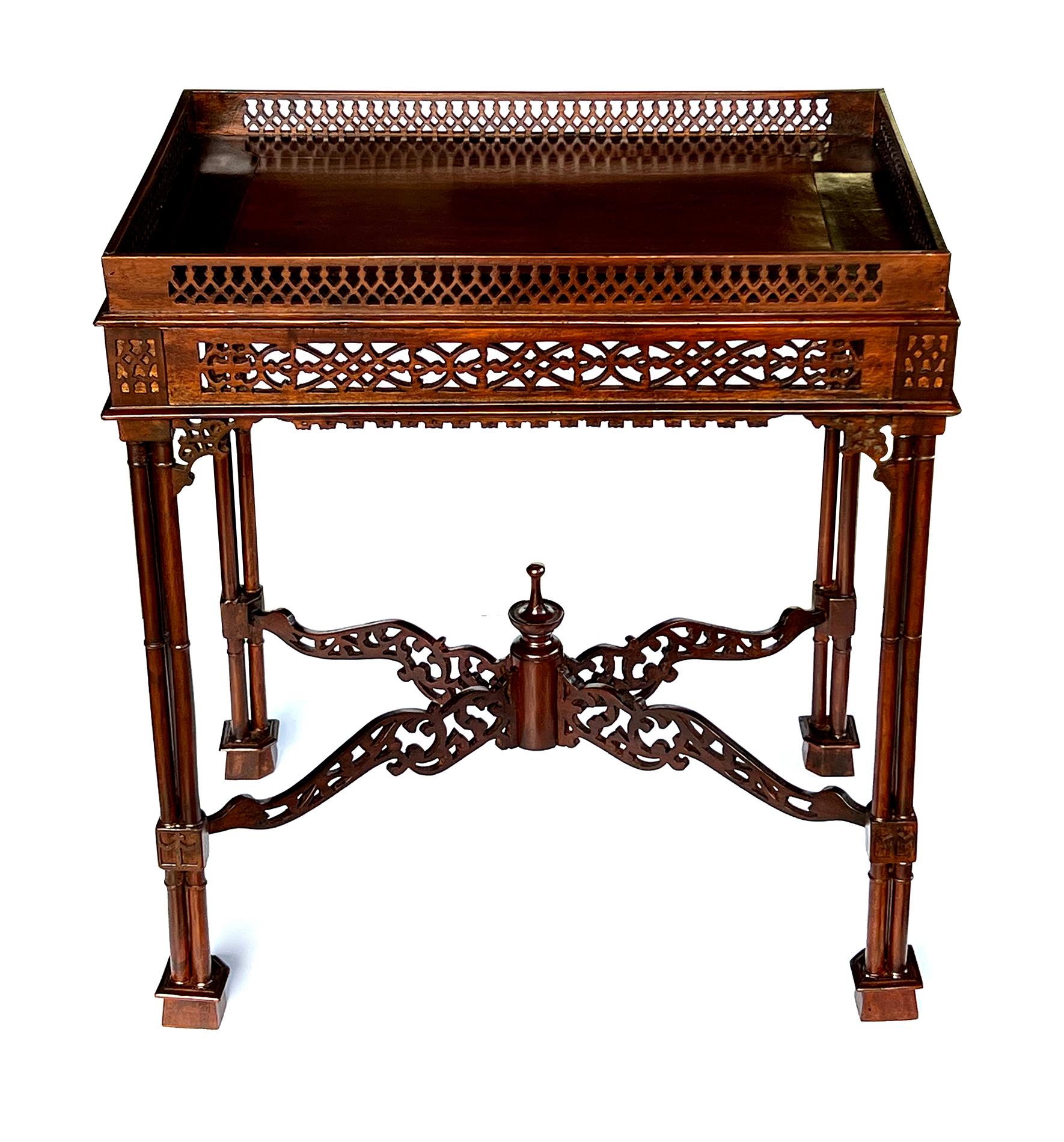 the rectangular top with pierced gallery and apron all raised on cluster column legs joined by an X-form fretwork stretcher centering an urn