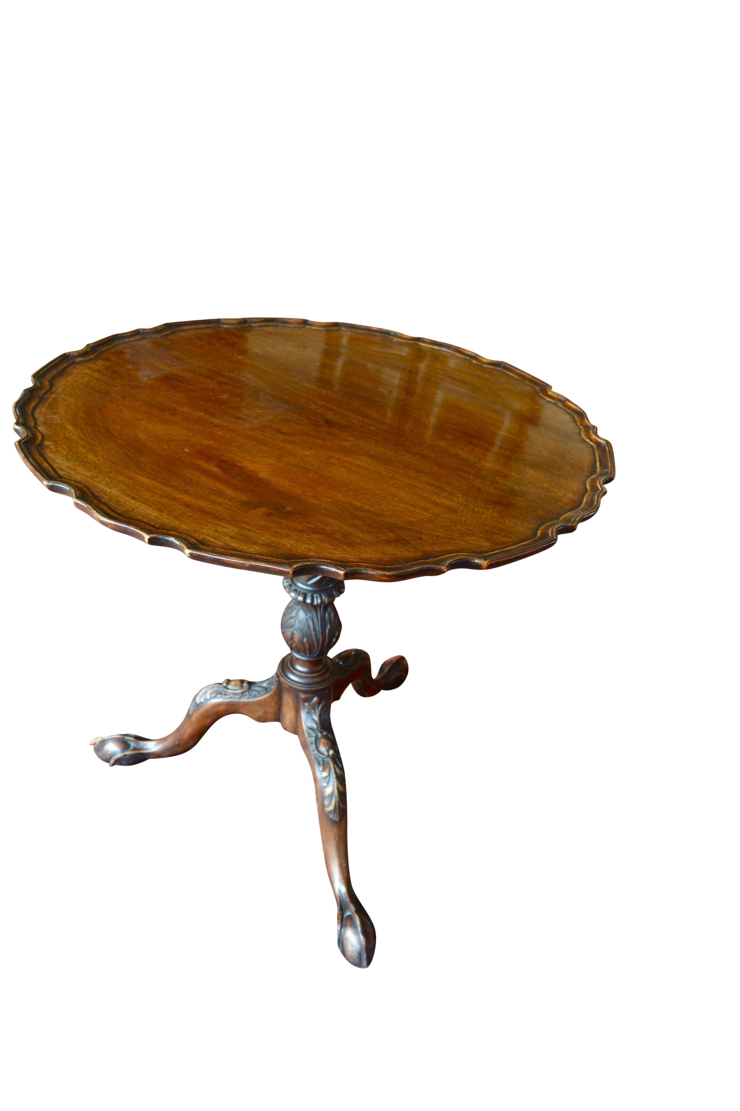 A tilt-top Chippendale style tea table in mahogany, with pie crust, dish top supported on an acanthus decorated turned pedestal, with a tripod base ending in claw and ball feet. The table in in excellent condition with strong figuring to the solid