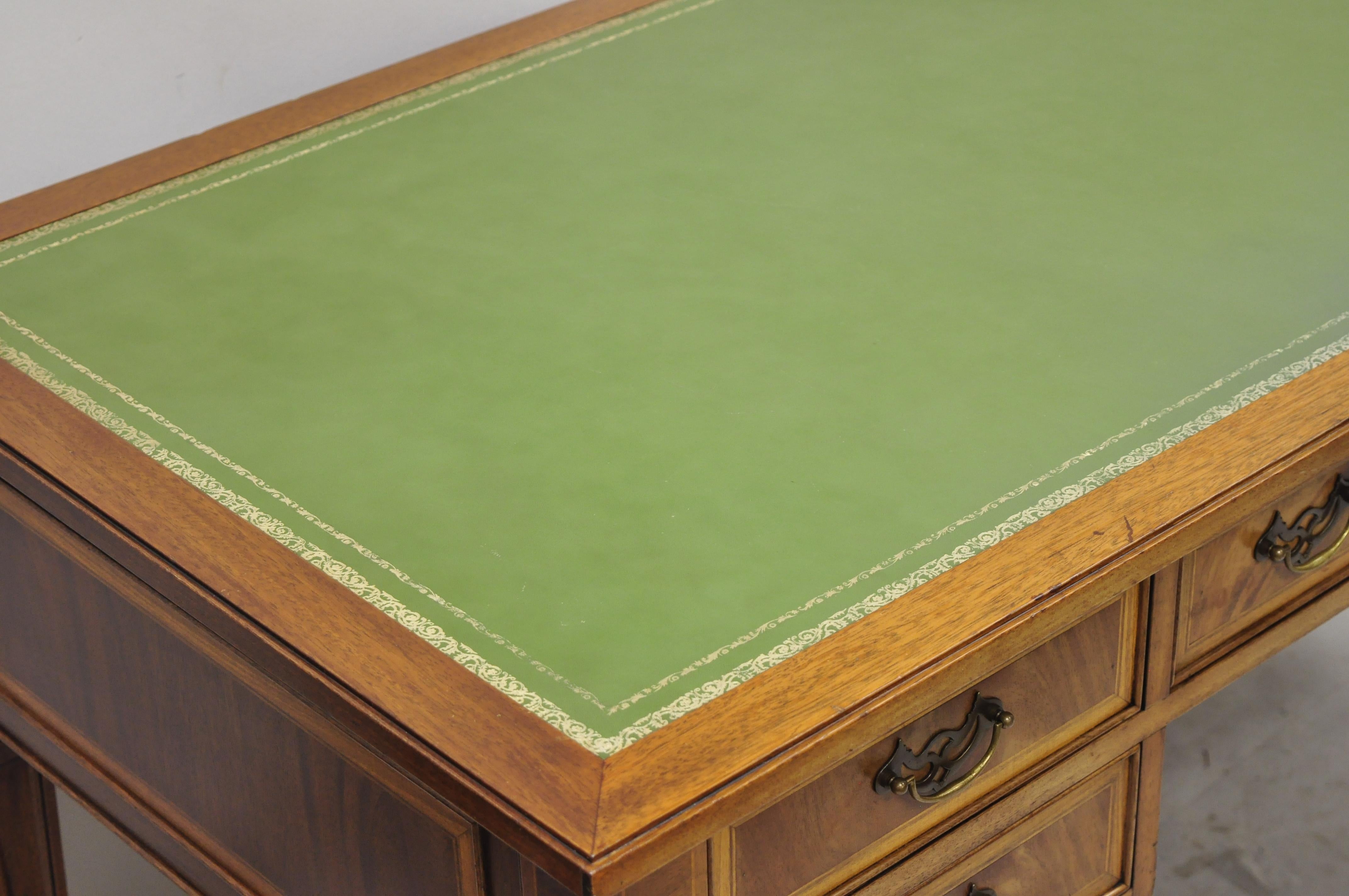 Vintage English Chippendale style green leather top crotch mahogany executive office desk. Item features green tooled leather top, solid wood construction, beautiful wood grain, finished back, 5 dovetailed drawers, tapered legs, very nice antique
