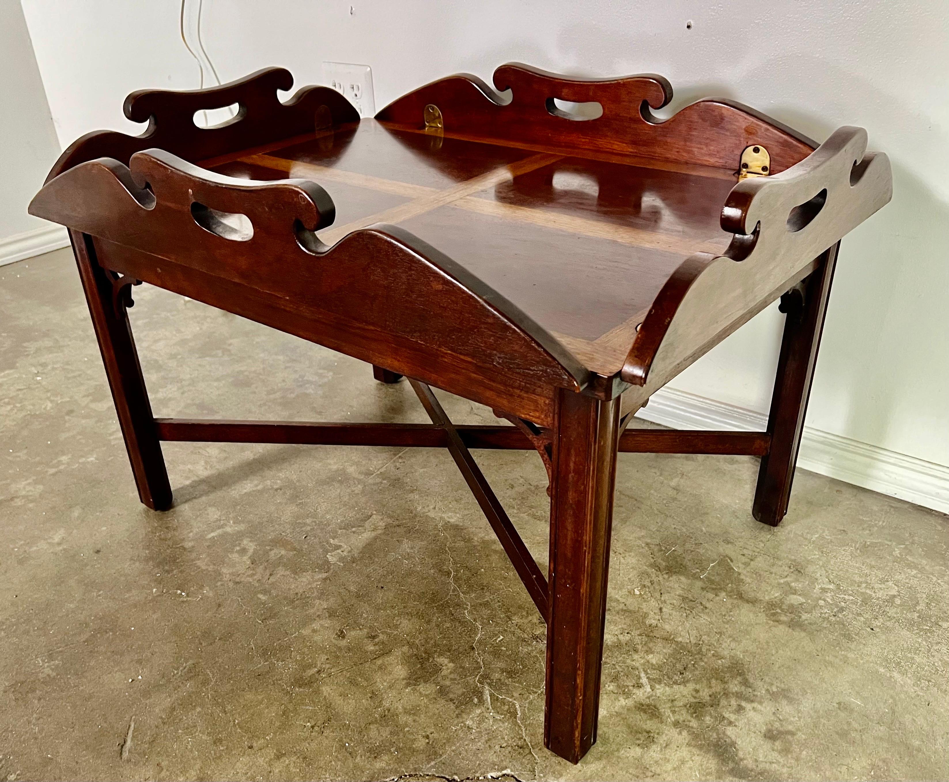 English Georgian Mohagany Inlaid butler's tray table.  This classic table was known for its versatility,   This table gallery has hinged lift up leaves with bright brass hardware.  A bottom 