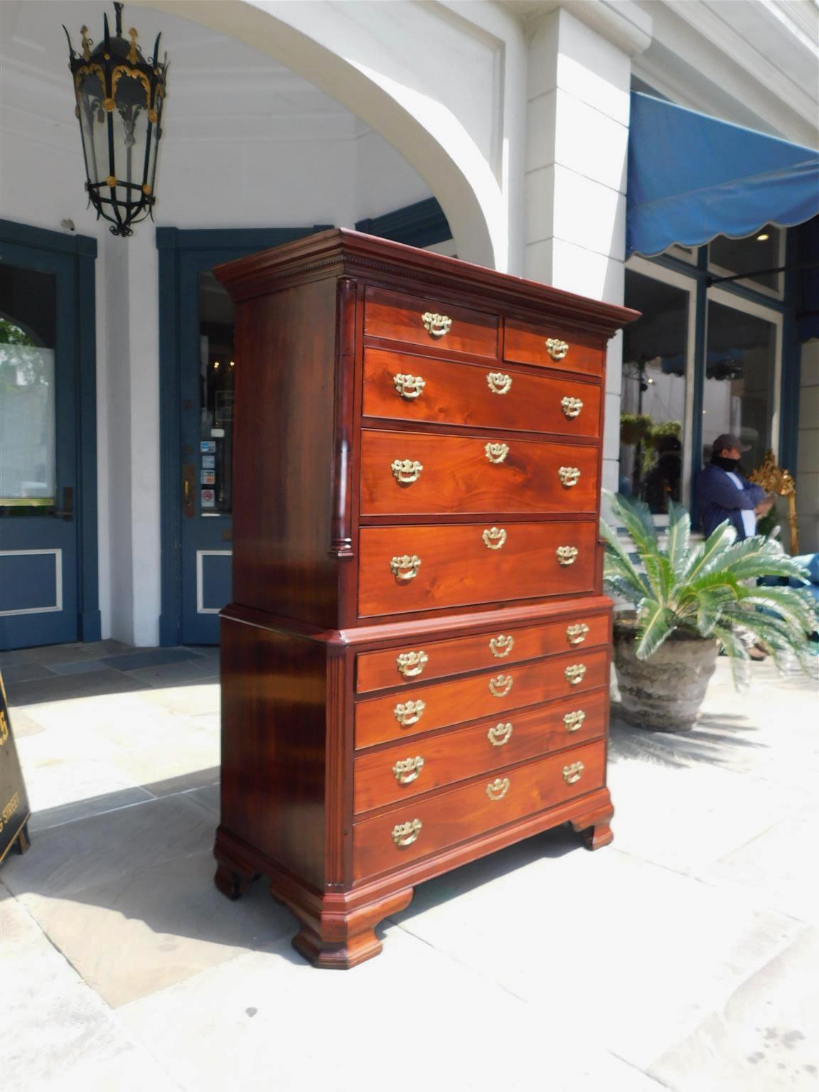 English Chippendale mahogany chest on chest with a carved candle light molded edge top , five upper case graduated drawers with the original brasses , carved fluted corner columns , four lower case graduated drawers with the original brasses, a