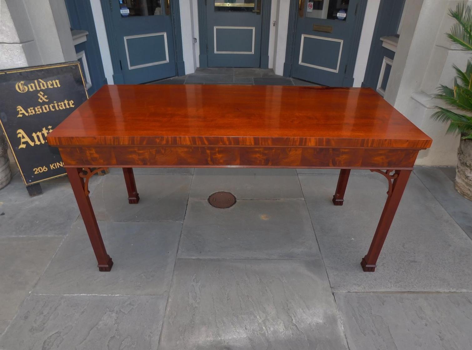 English Chippendale Mahogany console table with a carved molded edge one board top, flanking corner fret works, and resting on the original chamfered legs with Marlborough feet, late 18th century