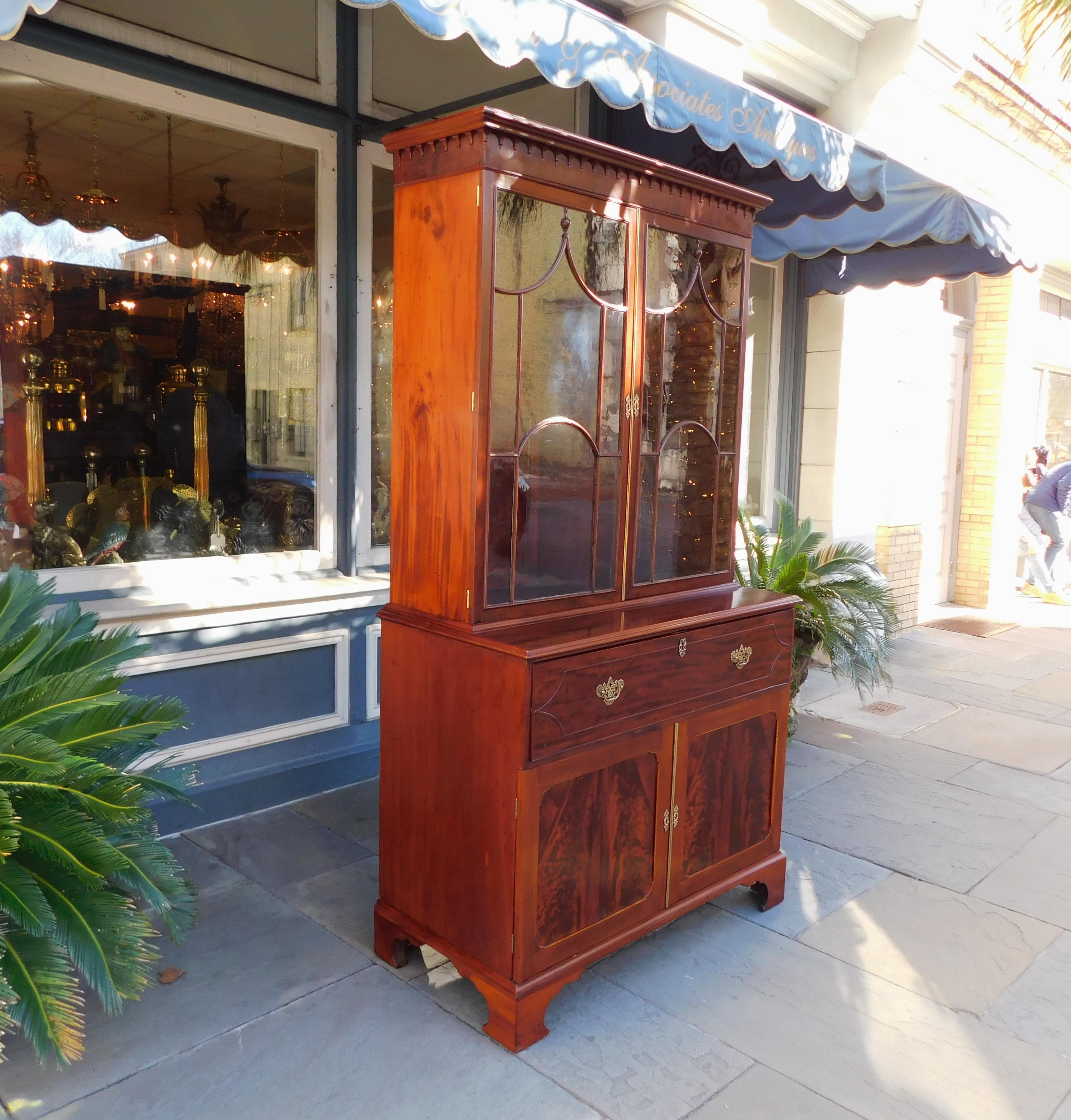 English Chippendale mahogany fall front secretary with carved molded edge finial cornice, flanking upper case hinged glass doors revealing adjustable interior shelves, period brasses, interior locks with keys, fitted interior burl walnut desk,