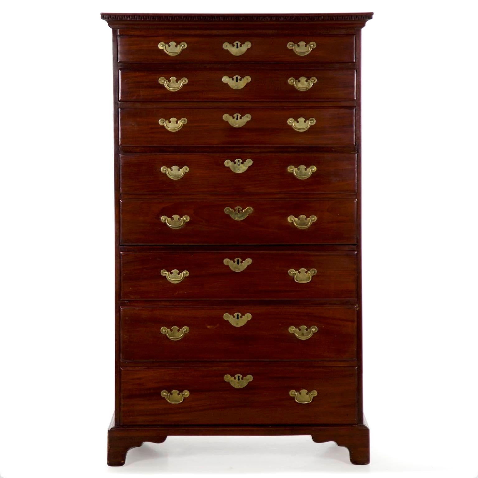 A very special piece of early English craftsmanship, this tall chest of drawers is executed in the finest selections of densely grained mahogany. Each plank has been carefully chosen for its pleasing character and smooth horizontal flow. The case