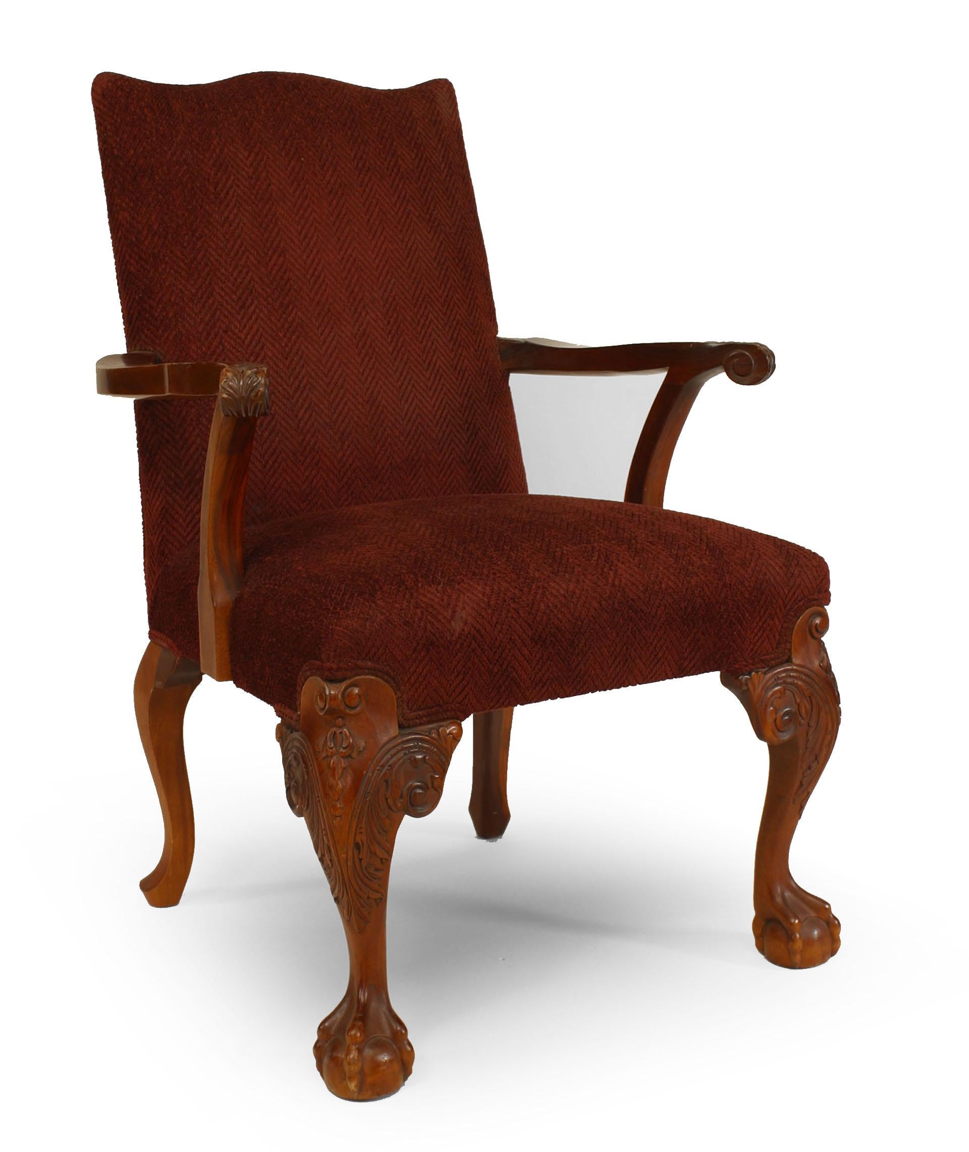 Pair of English Chippendale style (20th century) carved mahogany open arm chairs with maroon herringbone upholstery.