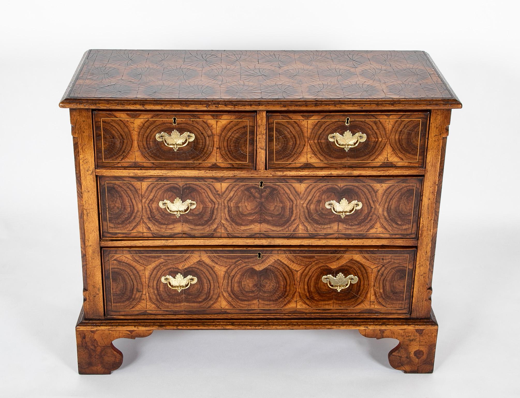 A wonderful medium scale four drawer commode with very handsome oyster veneer in the Chippendale style. The drawers with etched brass pulls. This piece was created by an master craftsman, you would only know it wasn't period by examining the