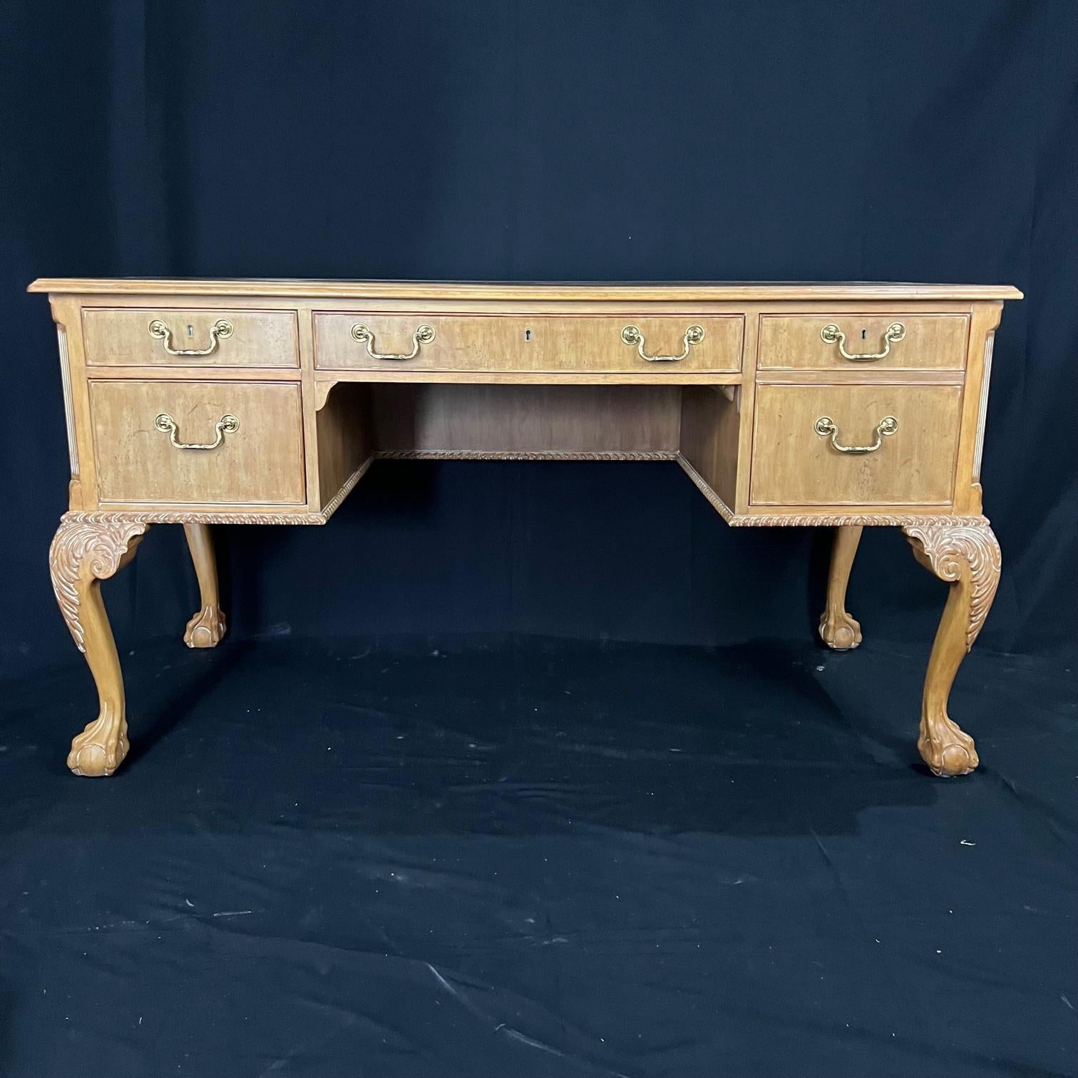 English Chippendale style bleached walnut ball & claw carved executive writing desk having rope carved edge, solid wood construction, beautiful light wood patina, finished back, and five drawers. The legs are long, elegant carved cabriolet legs with