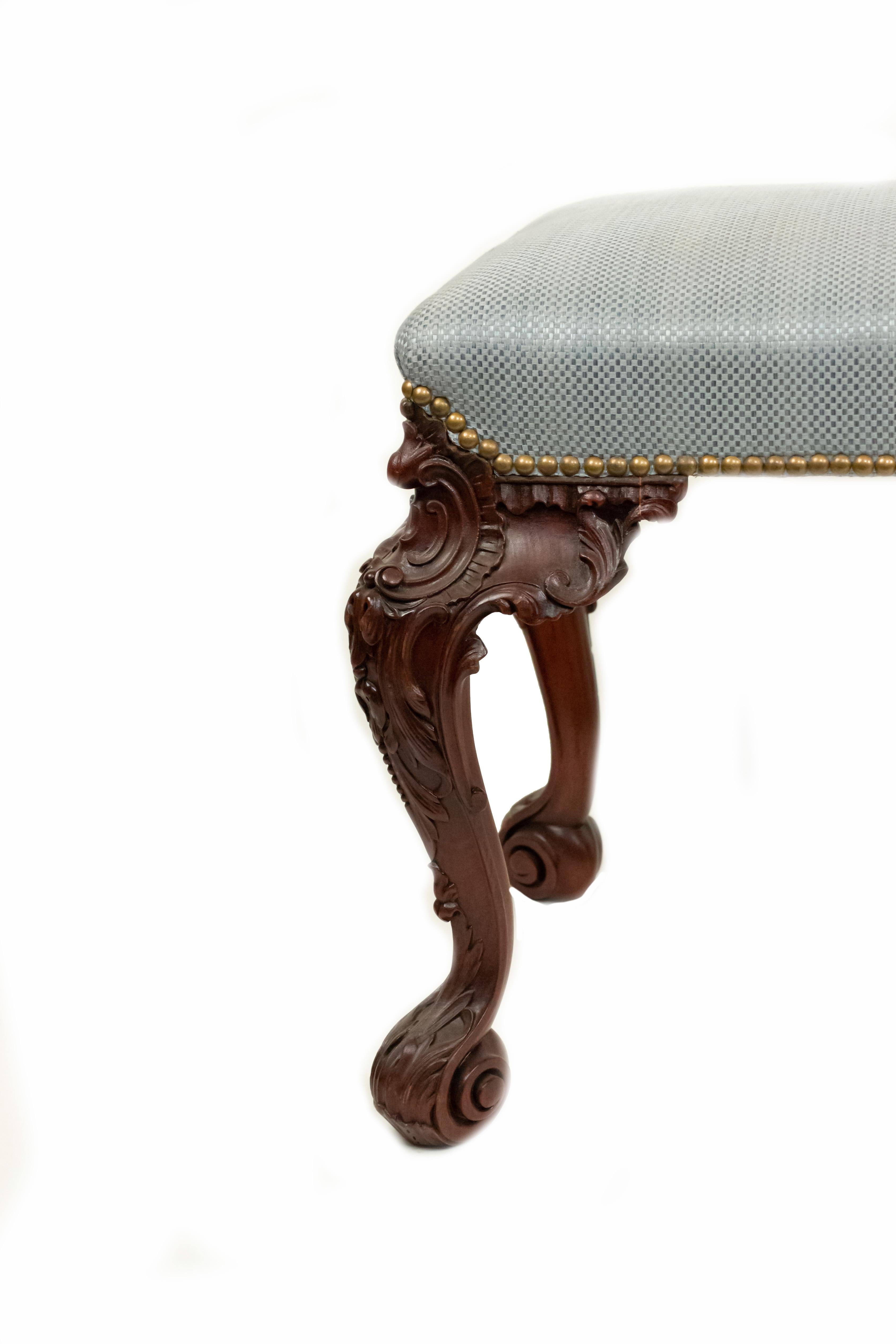 English Chippendale style (19th Century) rectangular carved mahogany bench with blue upholstery.
 