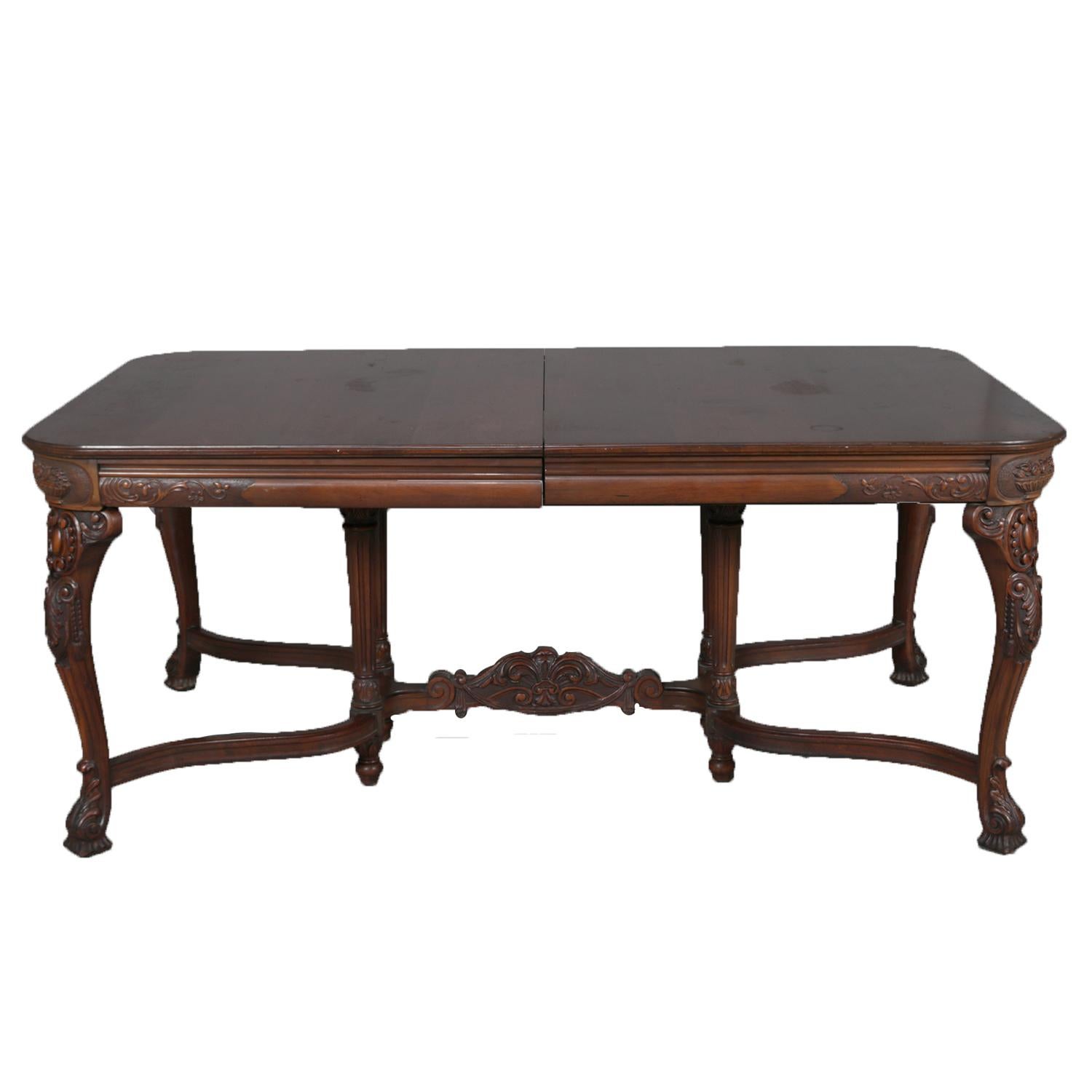 English Chippendale style carved walnut dining set includes table with carved skirt and raised on cabriole legs with shaped and carved stretcher and having four skirted leaves; chair set include two arm and four side with carved and pieced backs