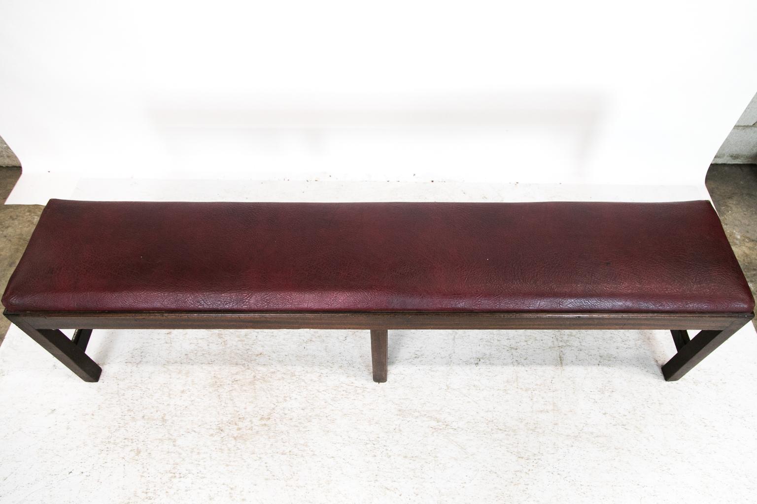 This long bench is made of solid mahogany. The top edge of the main frame and edges of the legs are molded. The heavy cross stretcher connects and supports the legs. The seat lifts out for easy recovering if needed.
  