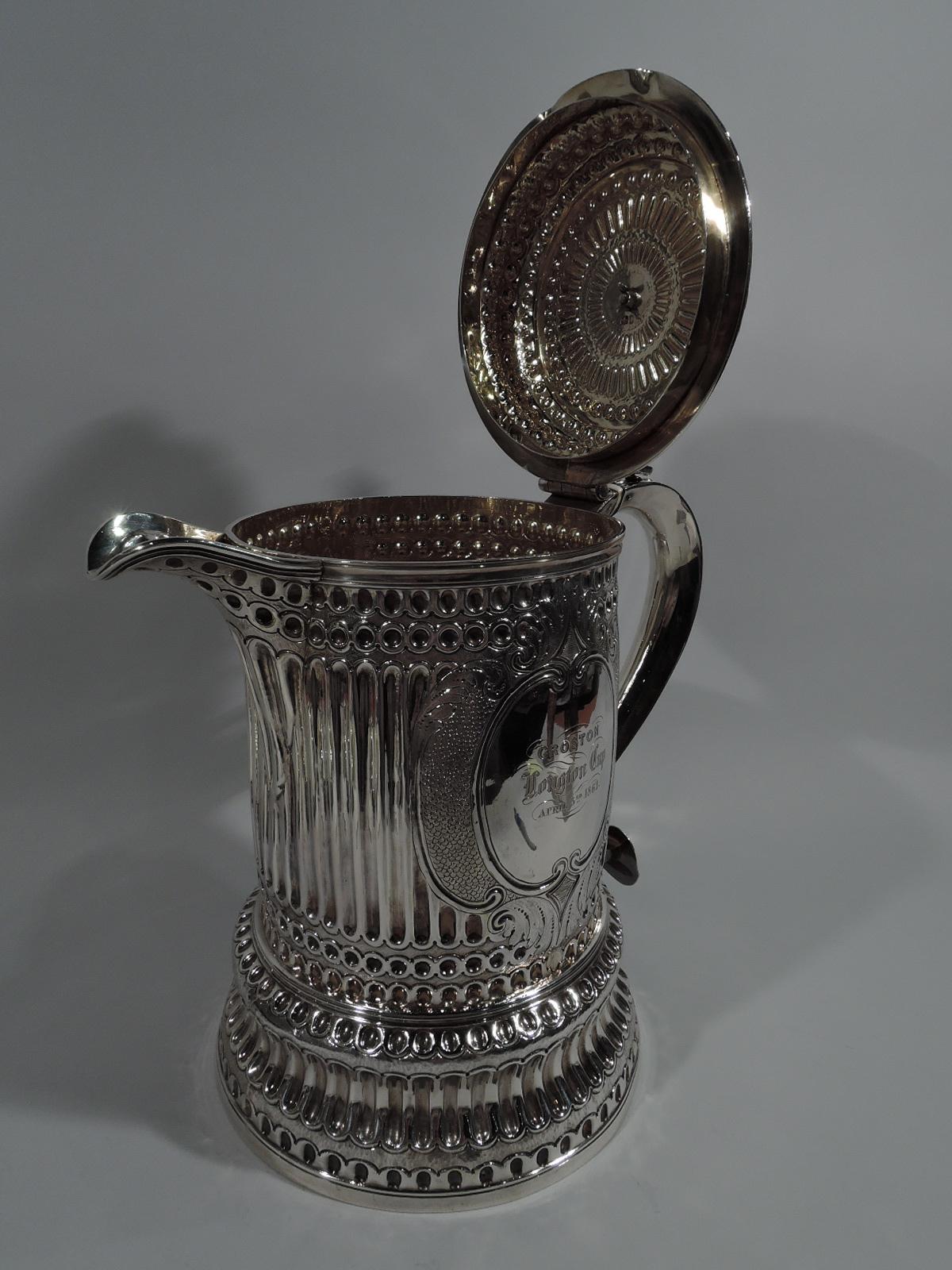 Victorian sterling silver horse racing tankard trophy in form of Classical column. Made in London in 1861. Shaft on concave case. S-scroll handle with graduated beading, and domed and raised cover with open thumb rest and large u-spout. Fluting and