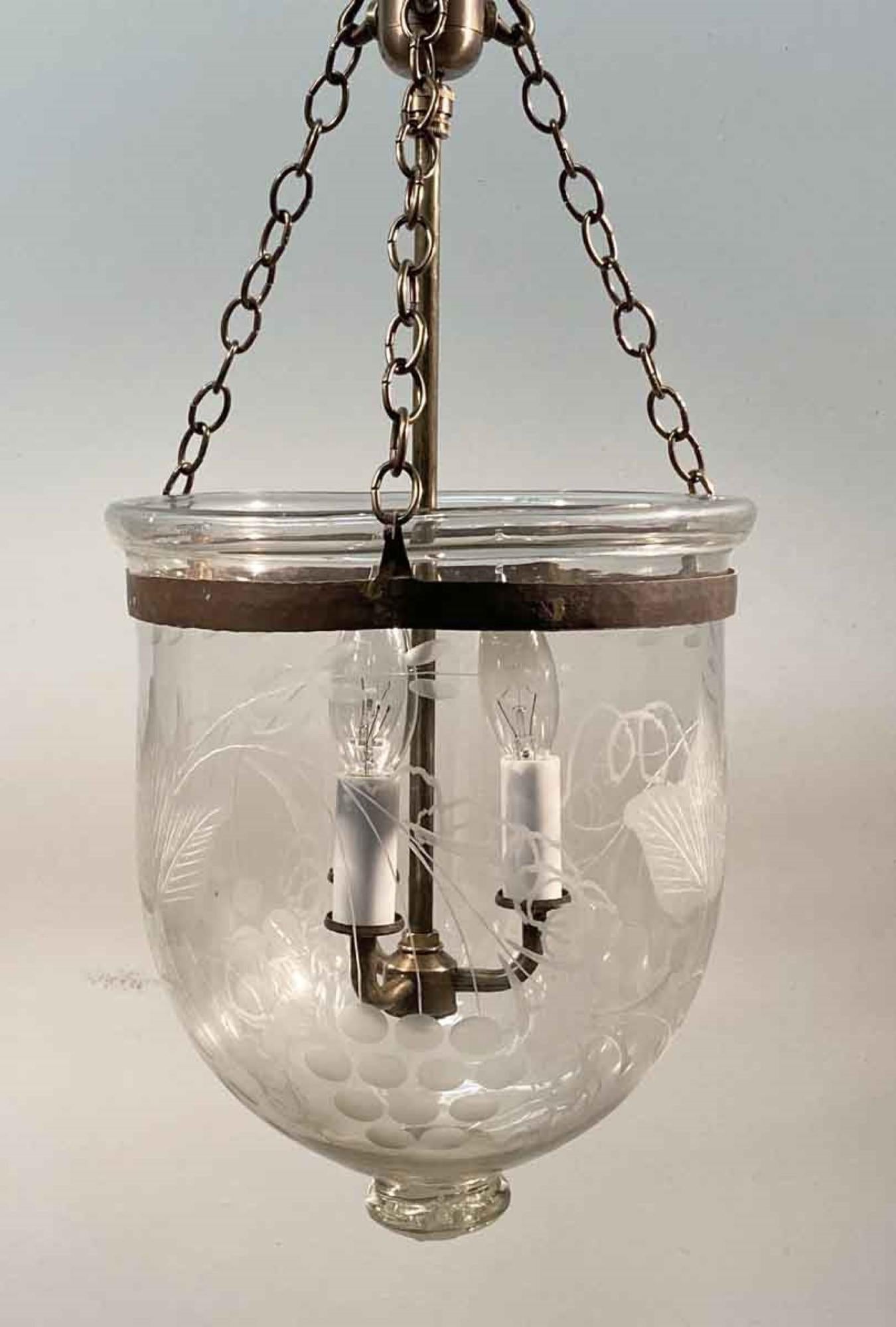 English hand blown glass bell jar lantern with etched floral decorative details, newly made brass hardware and three candelabra lights. This can be seen at our 400 Gilligan St location in Scranton. PA.