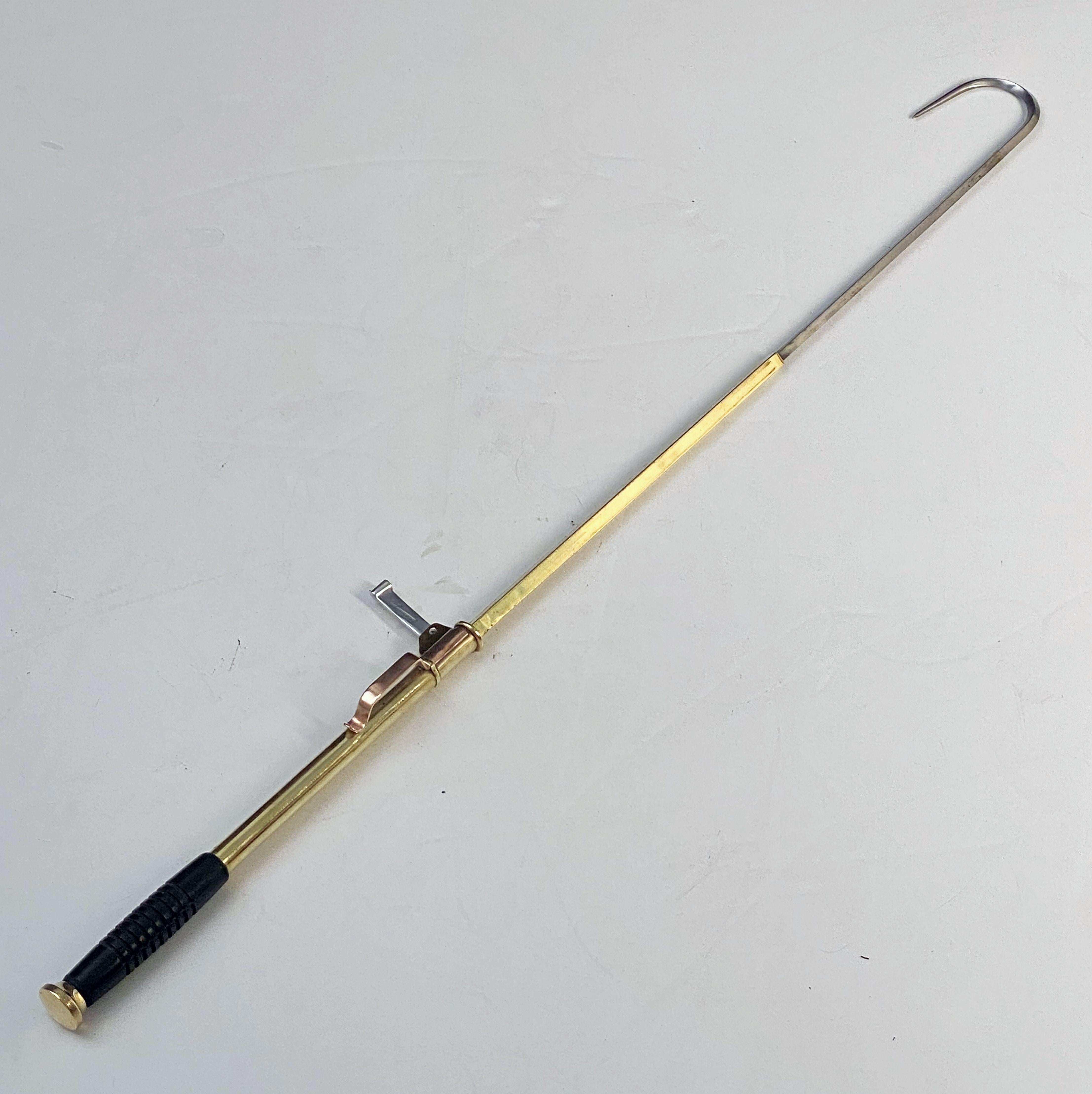 A fine English collapsible fishing or fisherman's gaff (hook) of brass, copper, and steel with a rubber grip handle, in working order.

Marked: Made in Great Britain

In fishing, a gaff is a pole with a sharp hook on the end that is used to stab