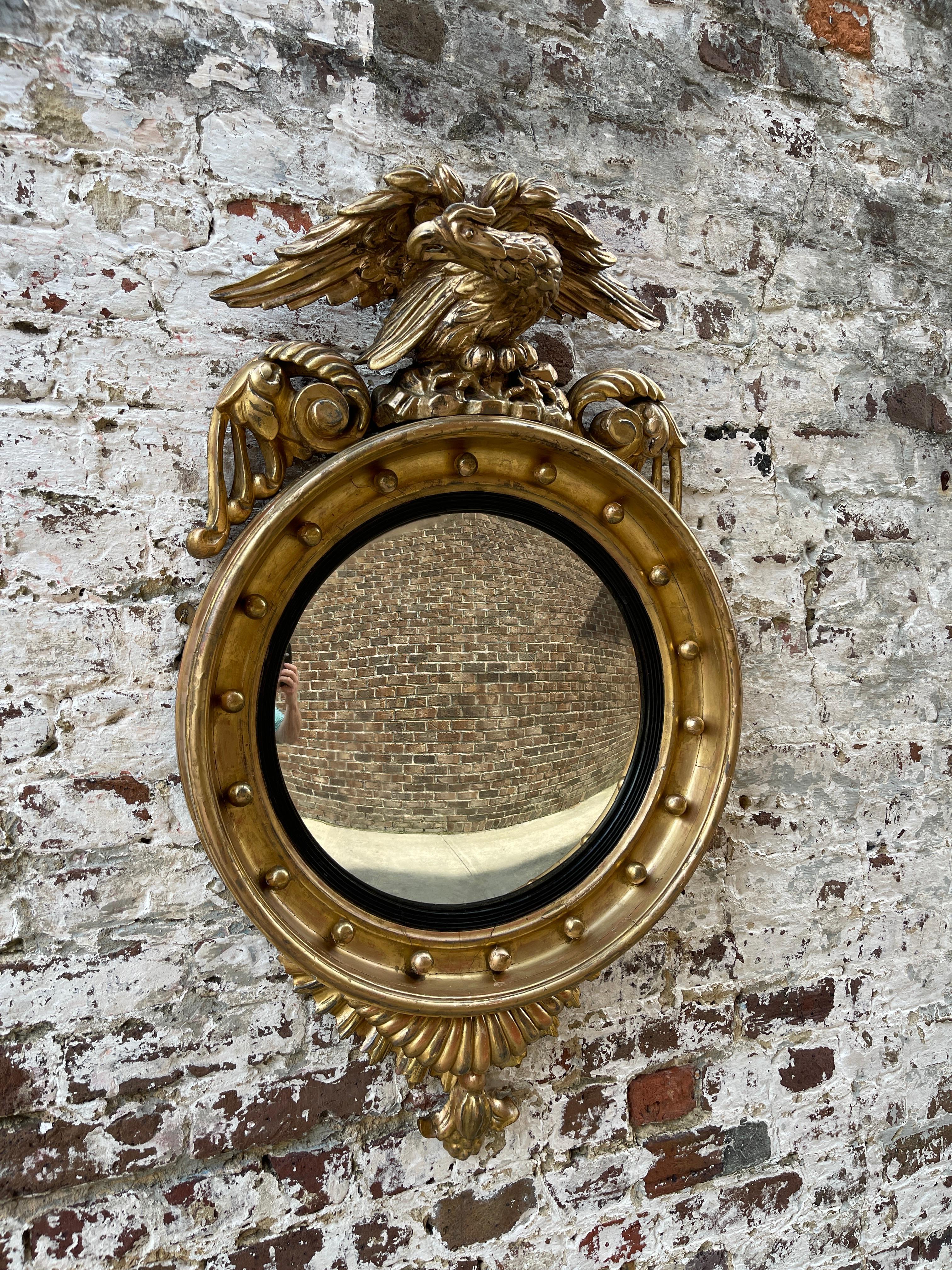 Gold Leaf English convex mirror with bold eagle on plinth 19th century  For Sale