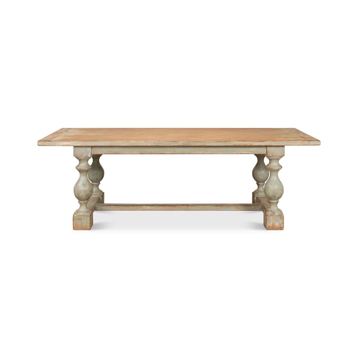 A Country style antique dining table with bold shapely turned baluster supports and an H stretcher base finished in an antiqued, distressed sage painted finish. Made of reclaimed pine with a breadboard end plank top.

Dimensions: 94