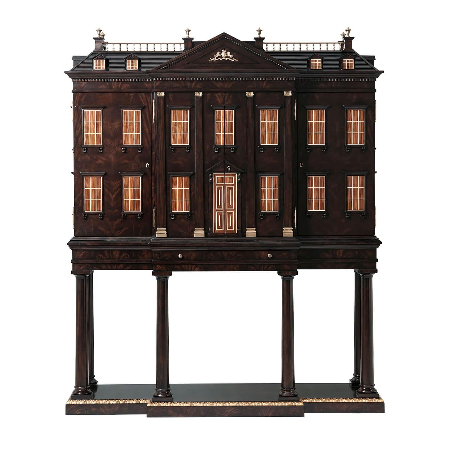 A very finely carved flame mahogany veneered architectural bar cabinet of the Althorp House façade, the upper section with a gabled brass galleried roof with 8 dormers, with a Spencer coat of arms pediment, the Cabinet with 21 Morado and Sycamore