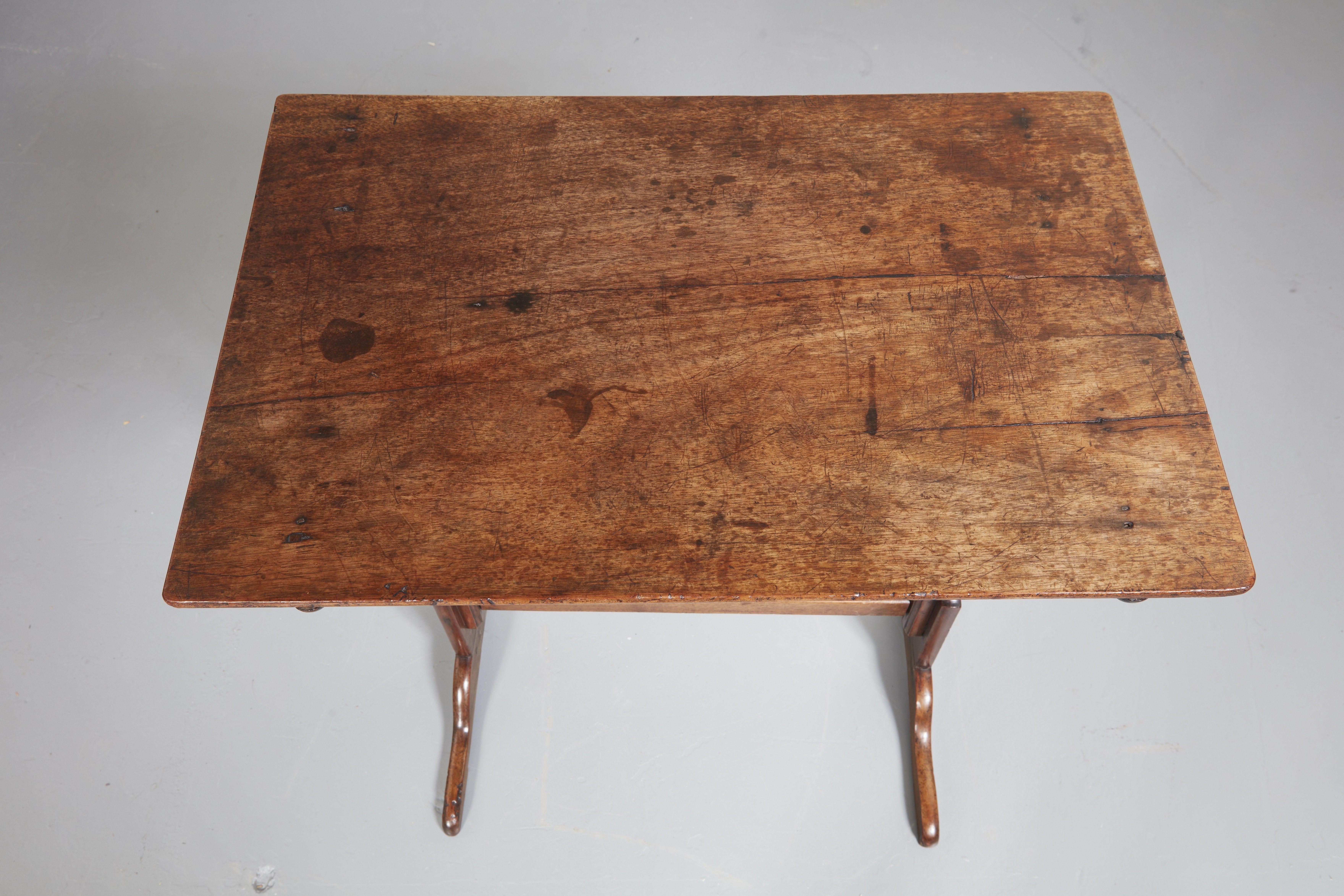 An English country house butler's table in attractively grained light mahogany having a rectangular top over vase splat shaped legs on wide tapered feet joined by a straight stretcher. Finished all the way around. Butler's tables are lightweight