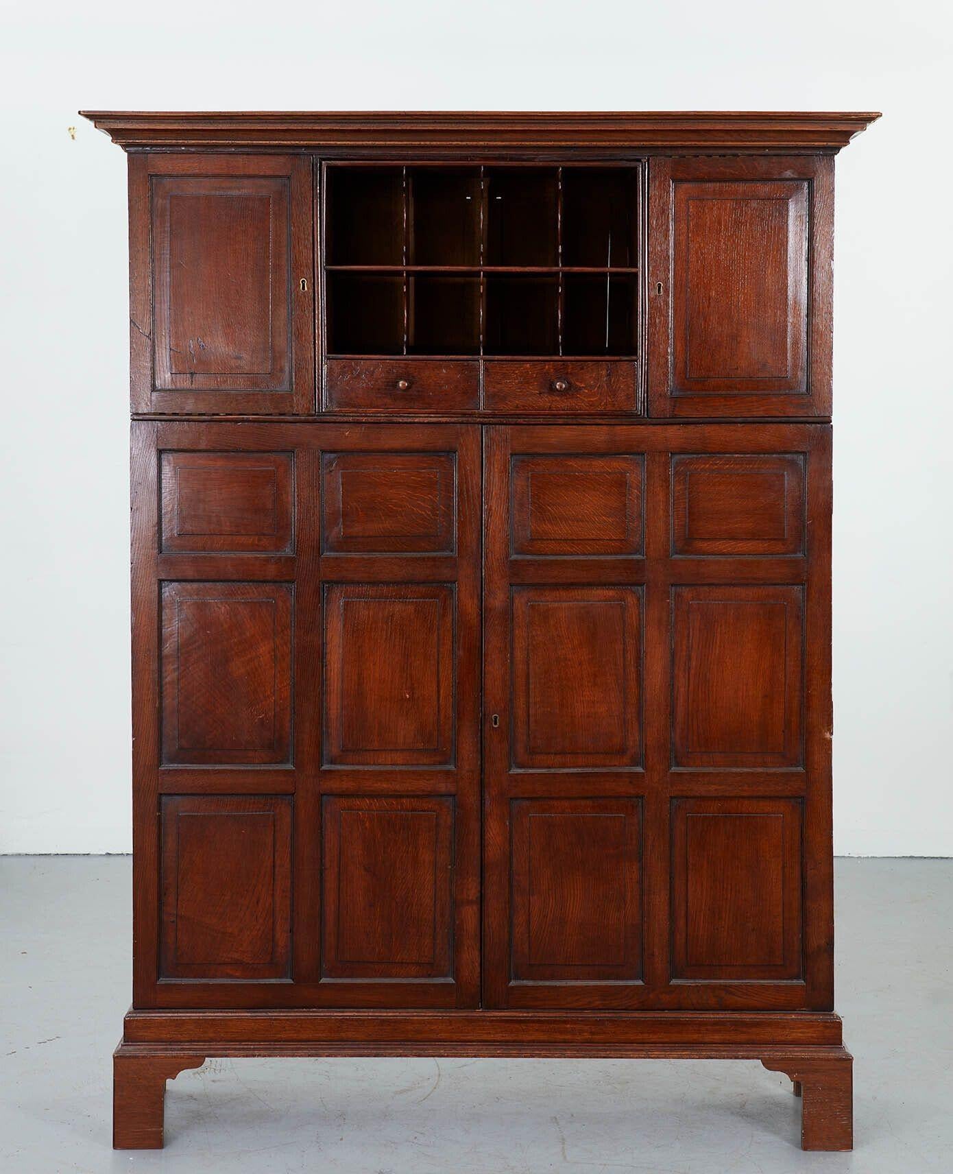 An early 19th century estate cabinet in polished oak from an English country house.  Accomplished estate-made craftsmanship and wonderful timber.  One of a kind.  This piece would have been housed in the estate office to keep the records.  Geometric