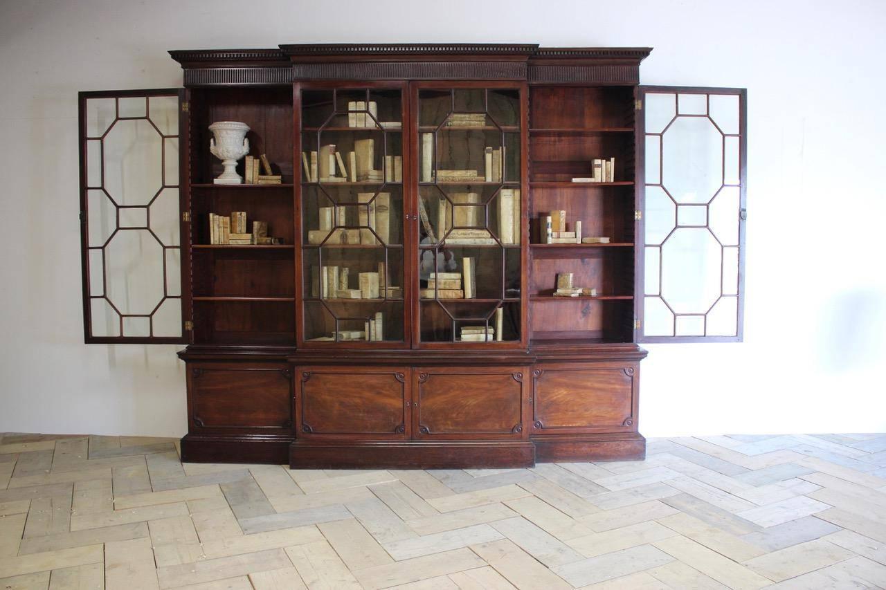 A fine quality and in untouched condition, late 18th century English George III mahogany breakfront bookcase with astragal doors, of great proportions, retaining the original glass, and with adjustable shelves.