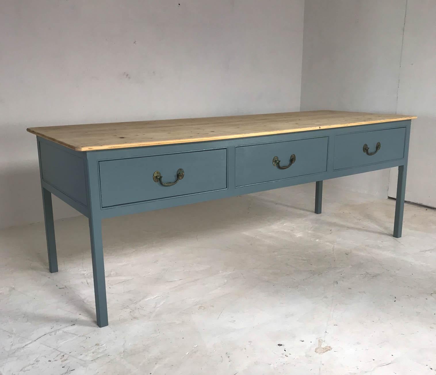 Georgian style kitchen prep table based on designs found in old English Country Homes. It has been hand painted in farrow and ball's new color, the elegant but down to earth De Nimes. The table features three large drawers with original antique
