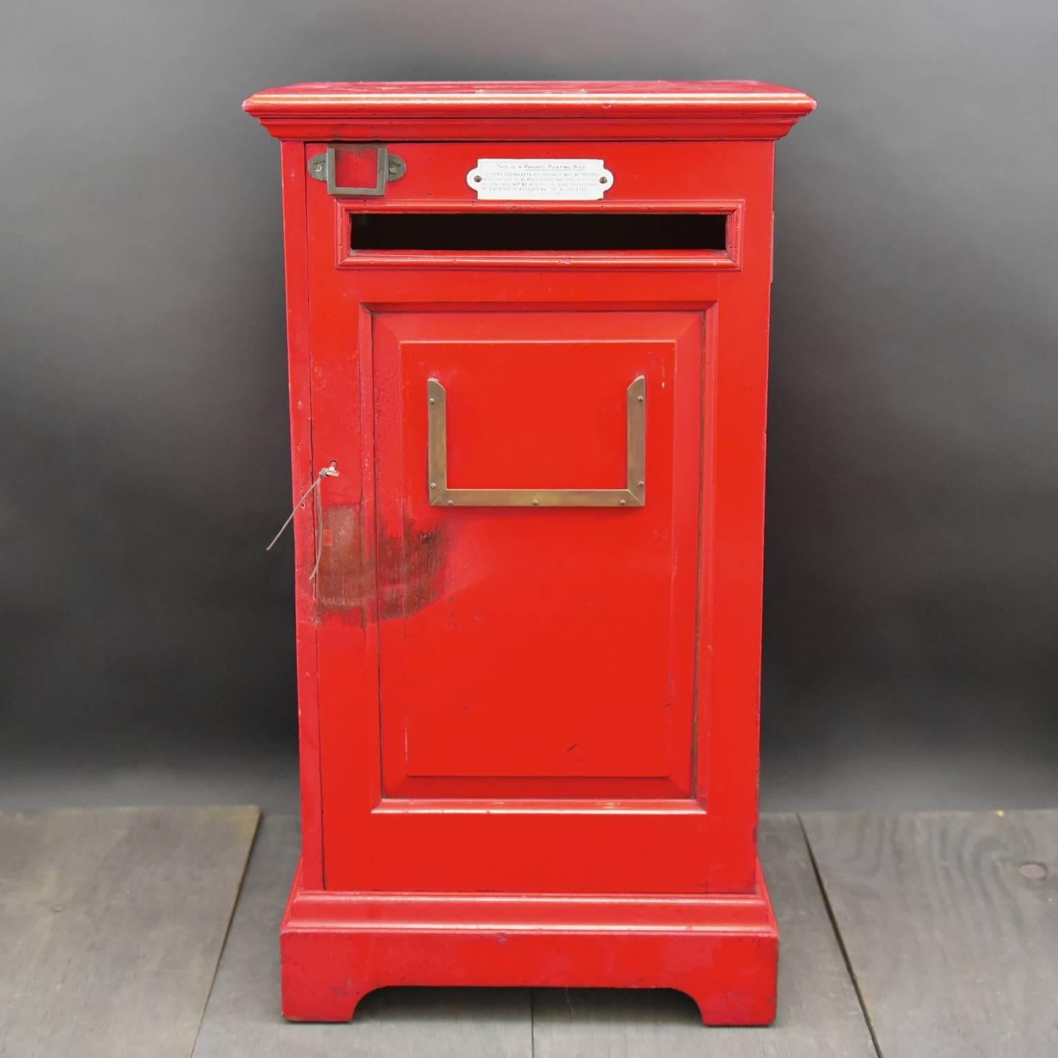 A fantastic painted wooden English 'country house' private red post box likely to have been made for the lobby of a hotel, business, club or a country house. It would have been emptied twice a day and the contents taken to the local Post Office,