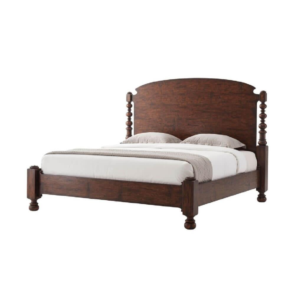 An English Country style reclaimed oak veneered and mahogany tester King size bed, with an arched headboard and four turned columns on a paneled foot rail, on turned legs.

Dimensions: 85.25