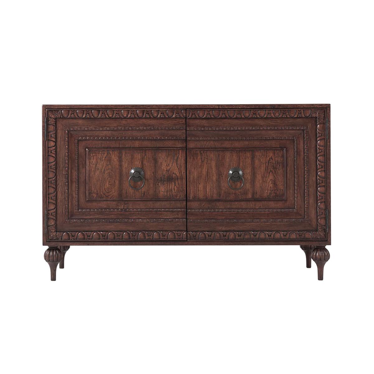 An English country oak cabinet, a solid oak and reclaimed oak veneered cabinet, with rectangular planked top and sides, two multiple step paneled doors with an outer border of egg & dart carving and further bands of acanthus and bell-flower carving;