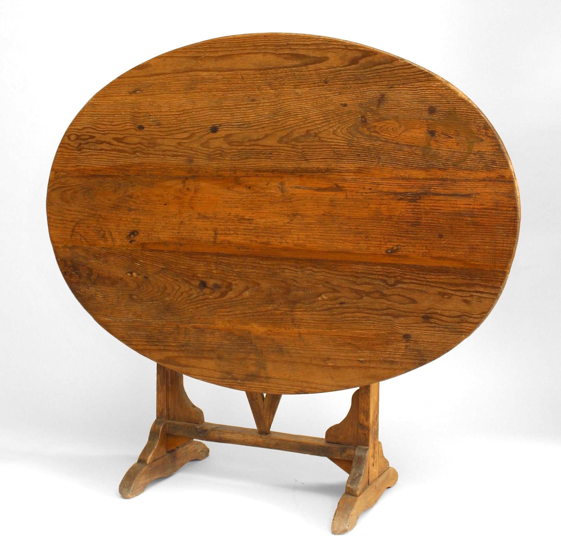 English country style (19th century) oval pine tilt-top end table with trestle base.

  