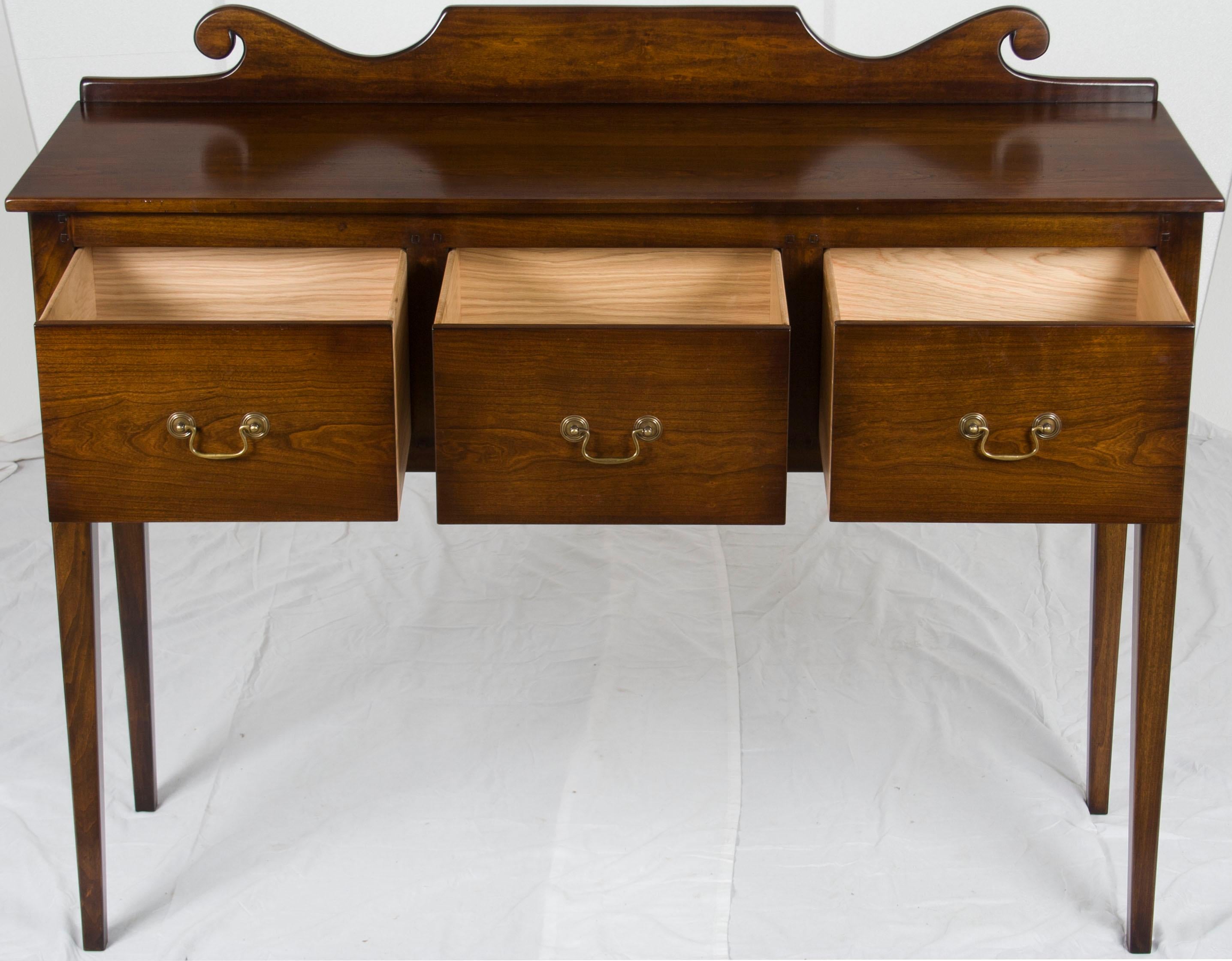 This antique country style huntboard is handmade in England using Georgian design and techniques. The solid cherry displays a rich, lustrous complexion and sweeping grain, enhanced by a long, careful process of hand-distressing, hand-finishing, and