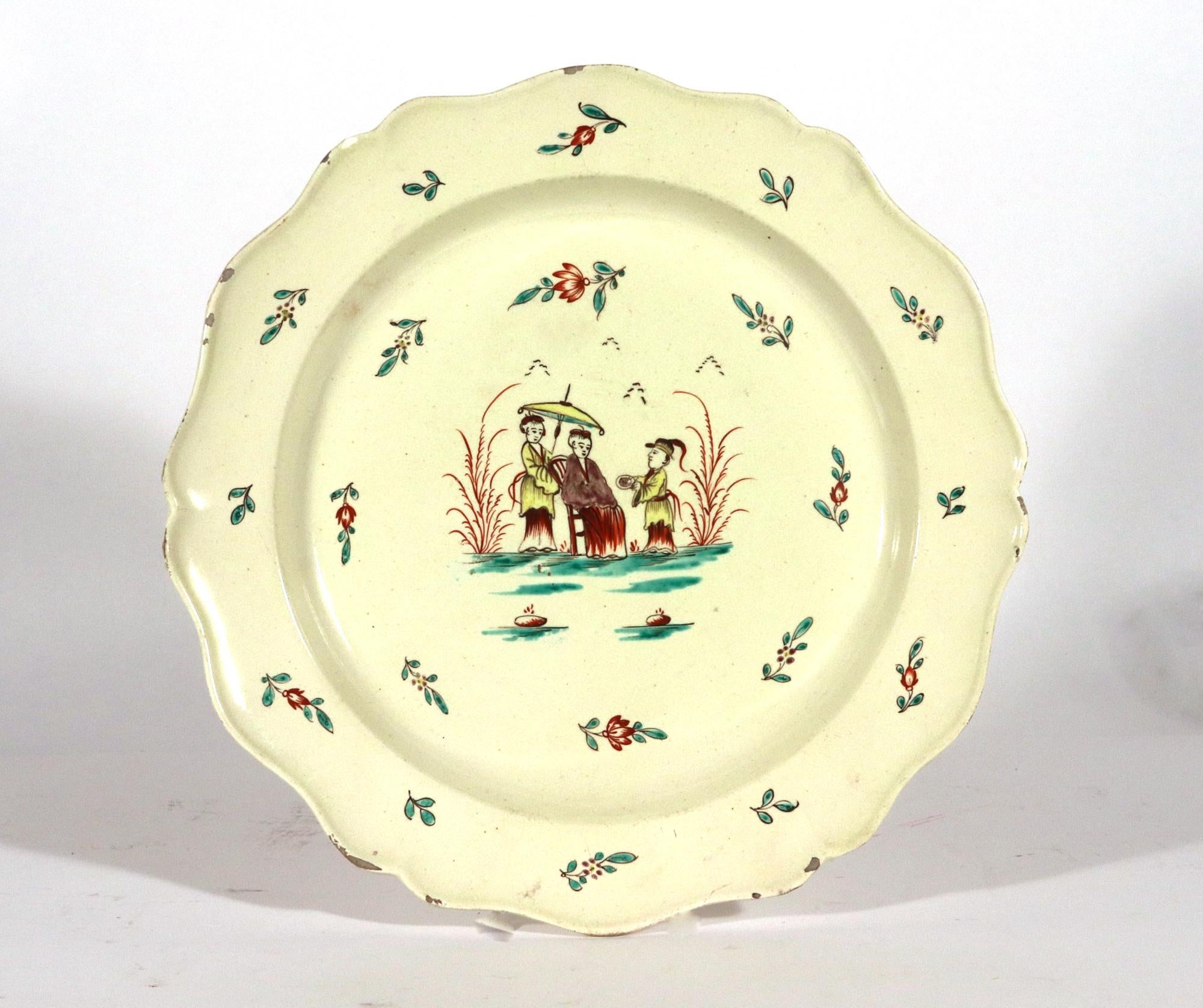 Creamware Large Dishes with Chinoiserie Decoration,
Circa 1775-85.

The large creamware dishes have a shaped rim with a slightly molded raised rim.  The center has a Chinoiserie design of a Chinese lady seated in a wood chair with two attendants,