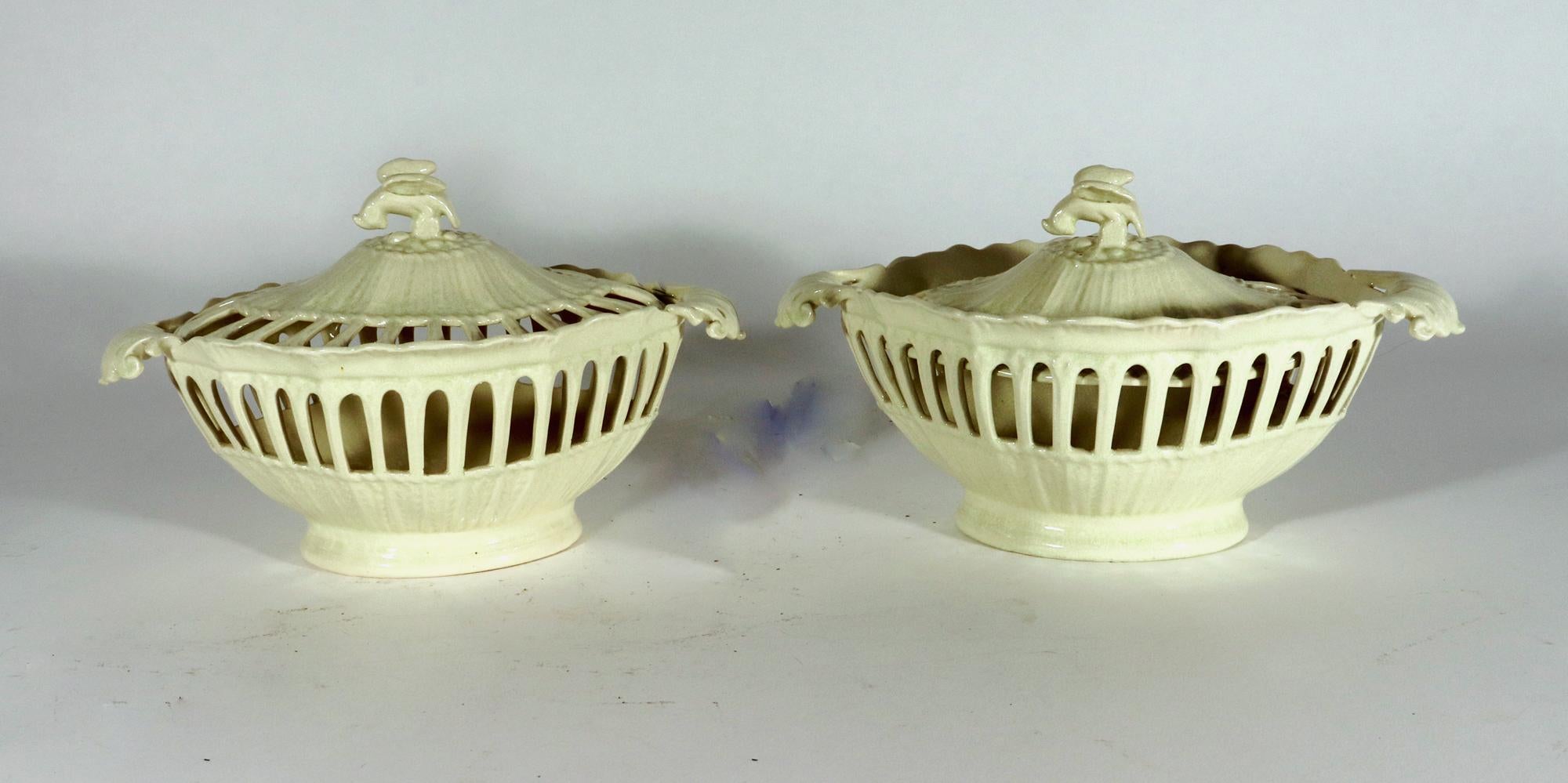 English Creamware Openwork Fruit Baskets and Covers,
Leeds Pottery,
1930s

The oval openwork plain creamware baskets and have a series of reeded openings to the central portion of the basket, below is a molded leaf within a lower column support. 