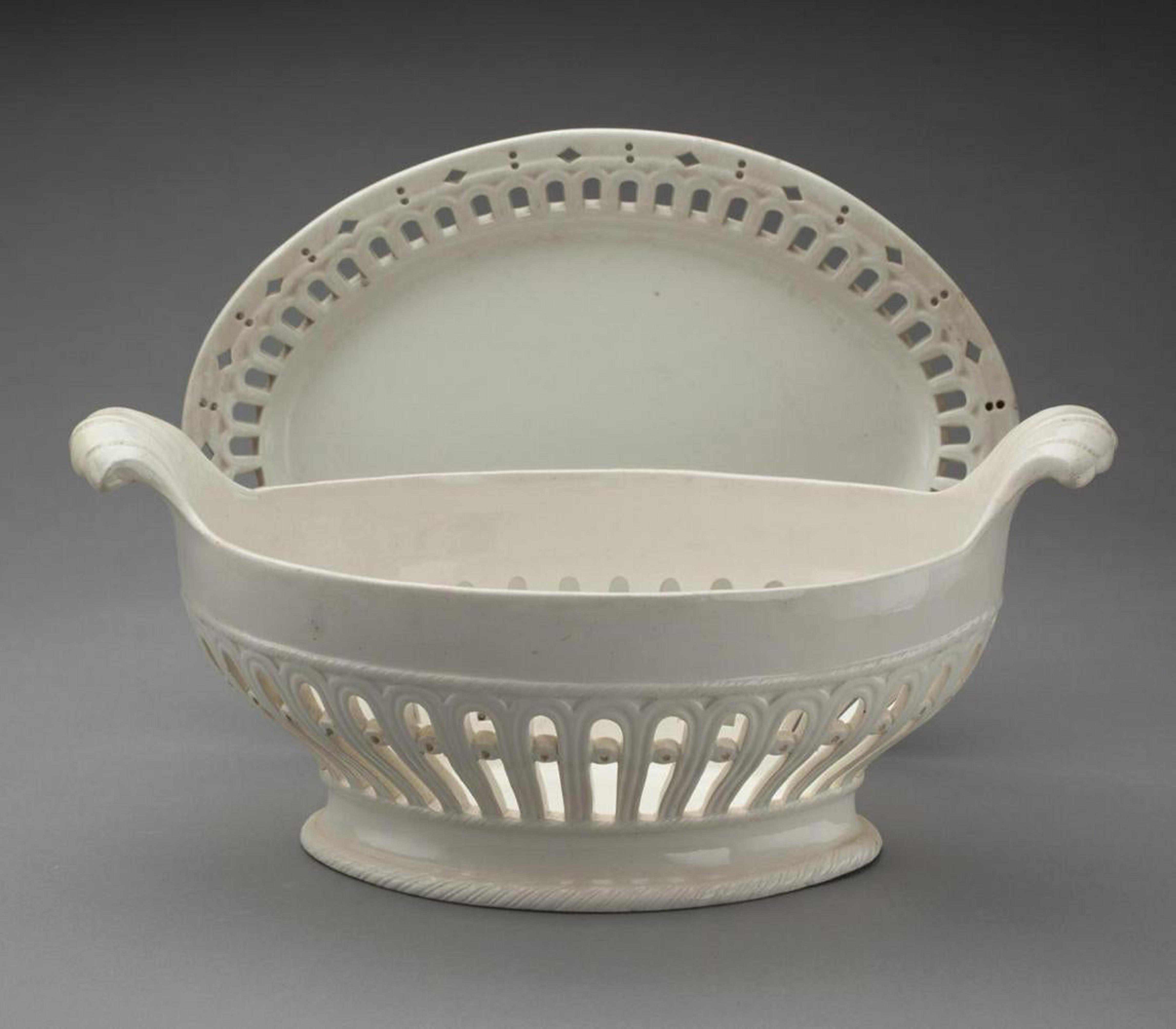 English creamware pottery fruit baskets and stands,
circa 1800


Pair of oval reticulated pearlware fruit baskets with scroll handles and reticulated stands.

Dimensions: Overall- 5 inches high x 10 1/4 inches x 7 1/2 inches wide, stand 7 1/2