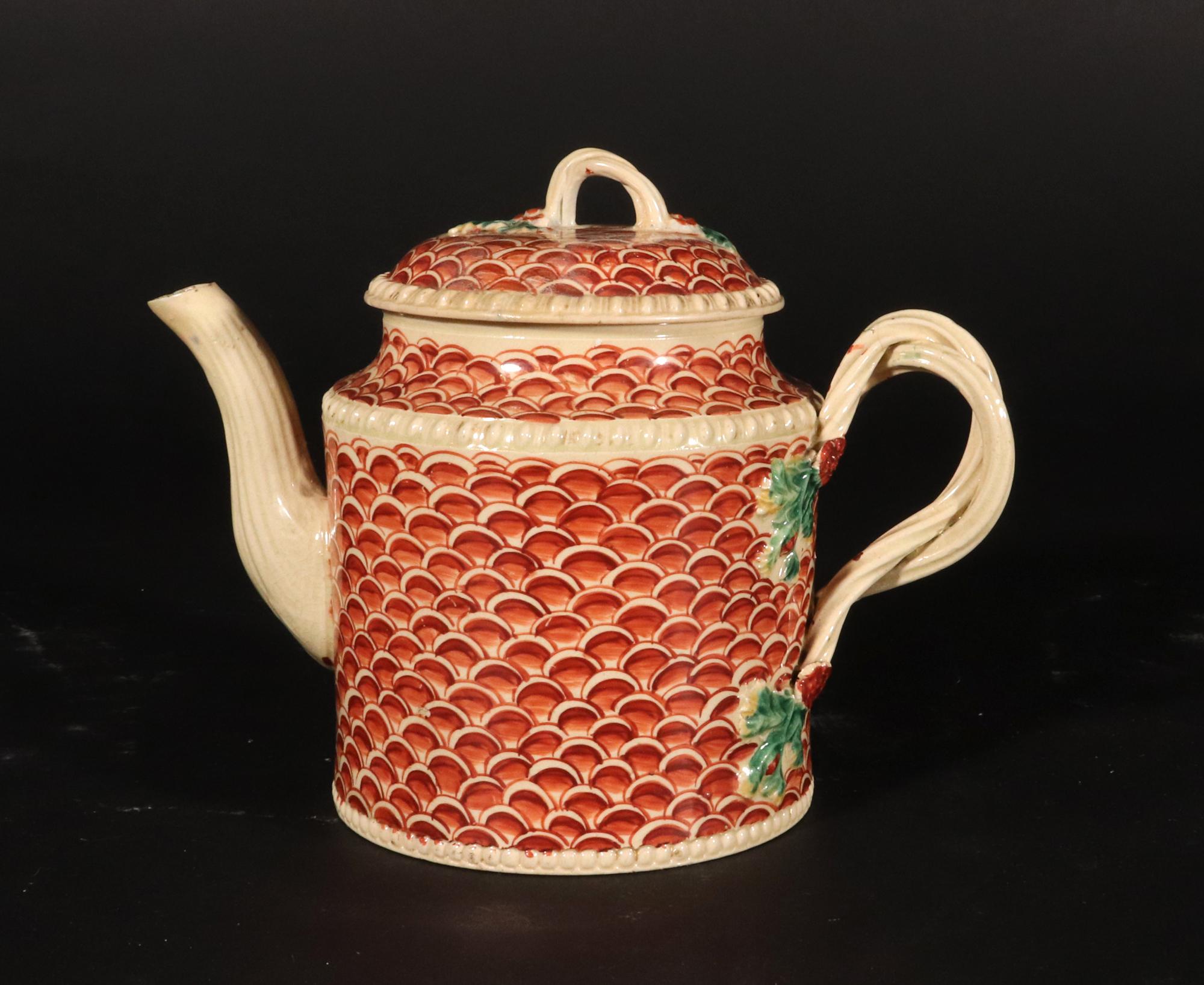  English Creamware Pottery Teapot and Cover with Rare Fish Scale Design

Origin: Probably Leeds, Yorkshire

Date: Circa 1770s

Description: This creamware teapot and cover exhibit a cylindrical form, featuring raised beading at the foot and shoulder