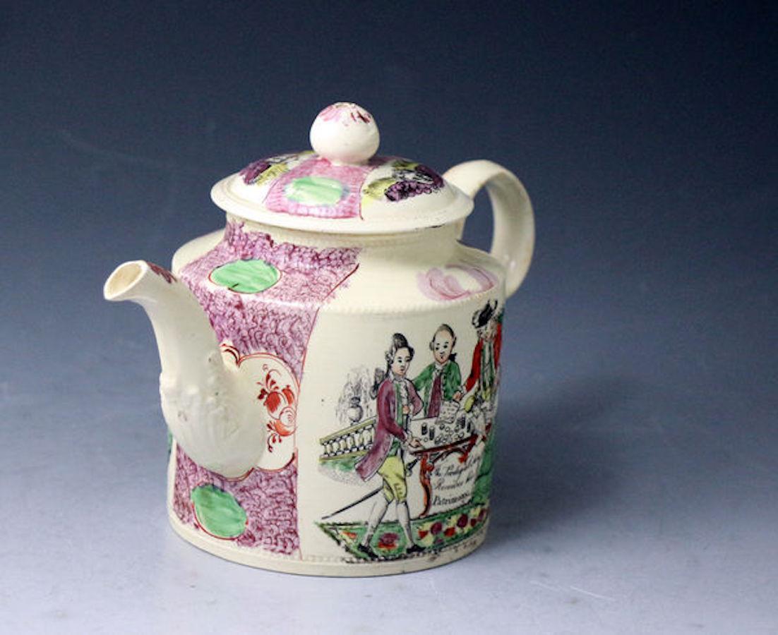 A William Greatbach cylindrical shaped pottery creamware teapot and cover. The handle is ear shaped and the cover has a ball shaped finial. The pot is decorated with underglaze black prints highlighted with enamel colors of the Prodical Son Taking