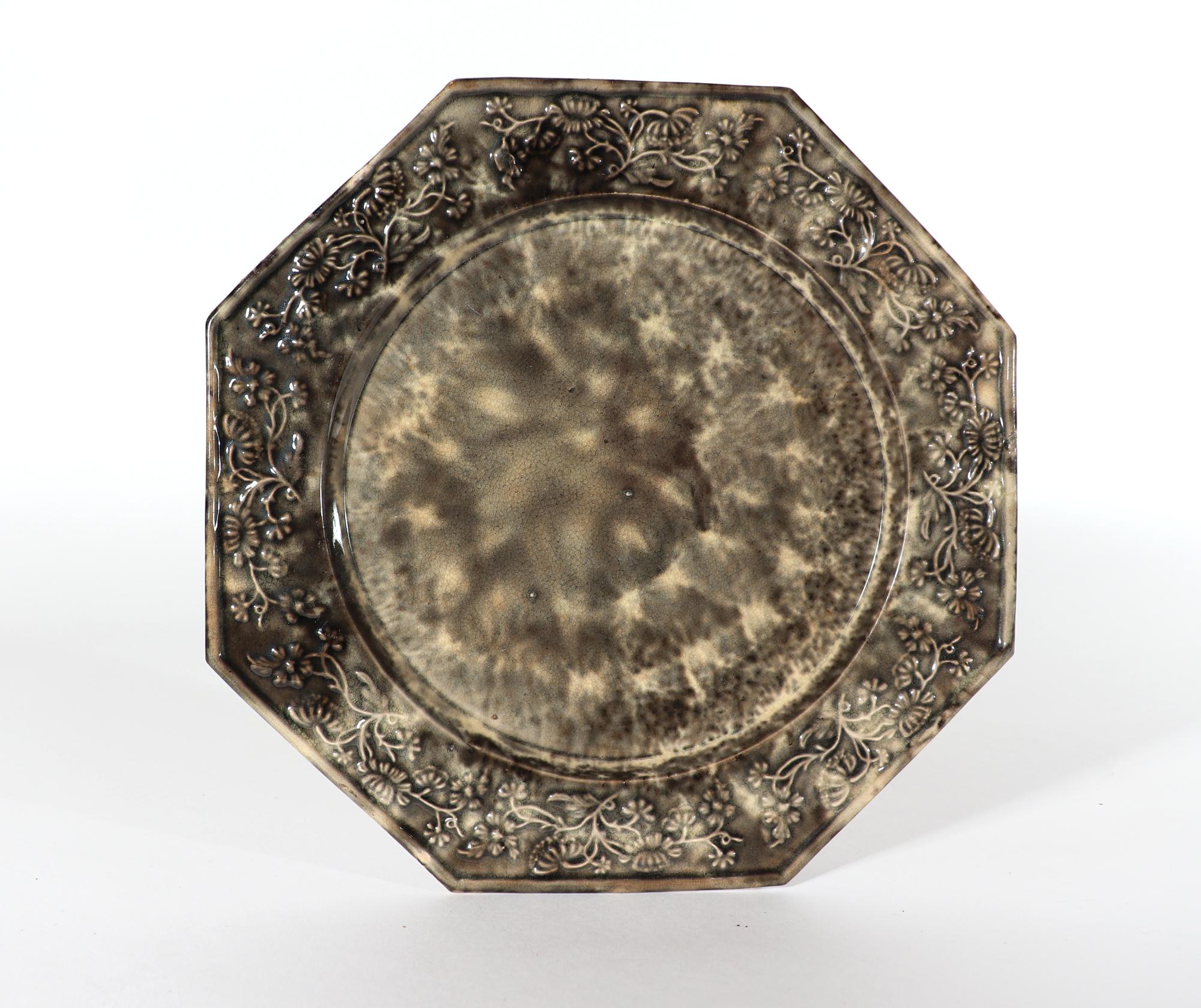 English Creamware Whieldon-type Gray Tortoiseshell Plate,
Circa 1765-75

The octagonal shaped plate is covered to the front and back with a very pleasing gray tortoise-shell pattern.  The rim is raised and the border has an unusual design of