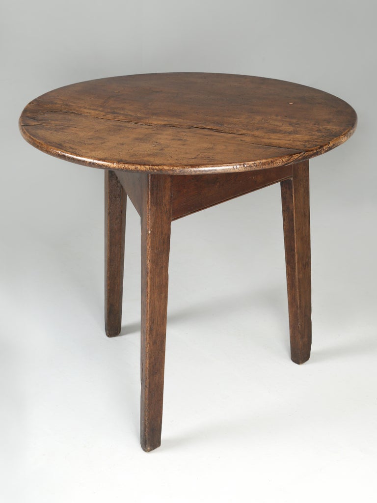 Antique English cricket table crafted from solid white oak with a truly impressive all original patina. The cricket table appears to never have been restored and upon its arrival in Chicago, we applied several coats of beeswax as to not disturb the
