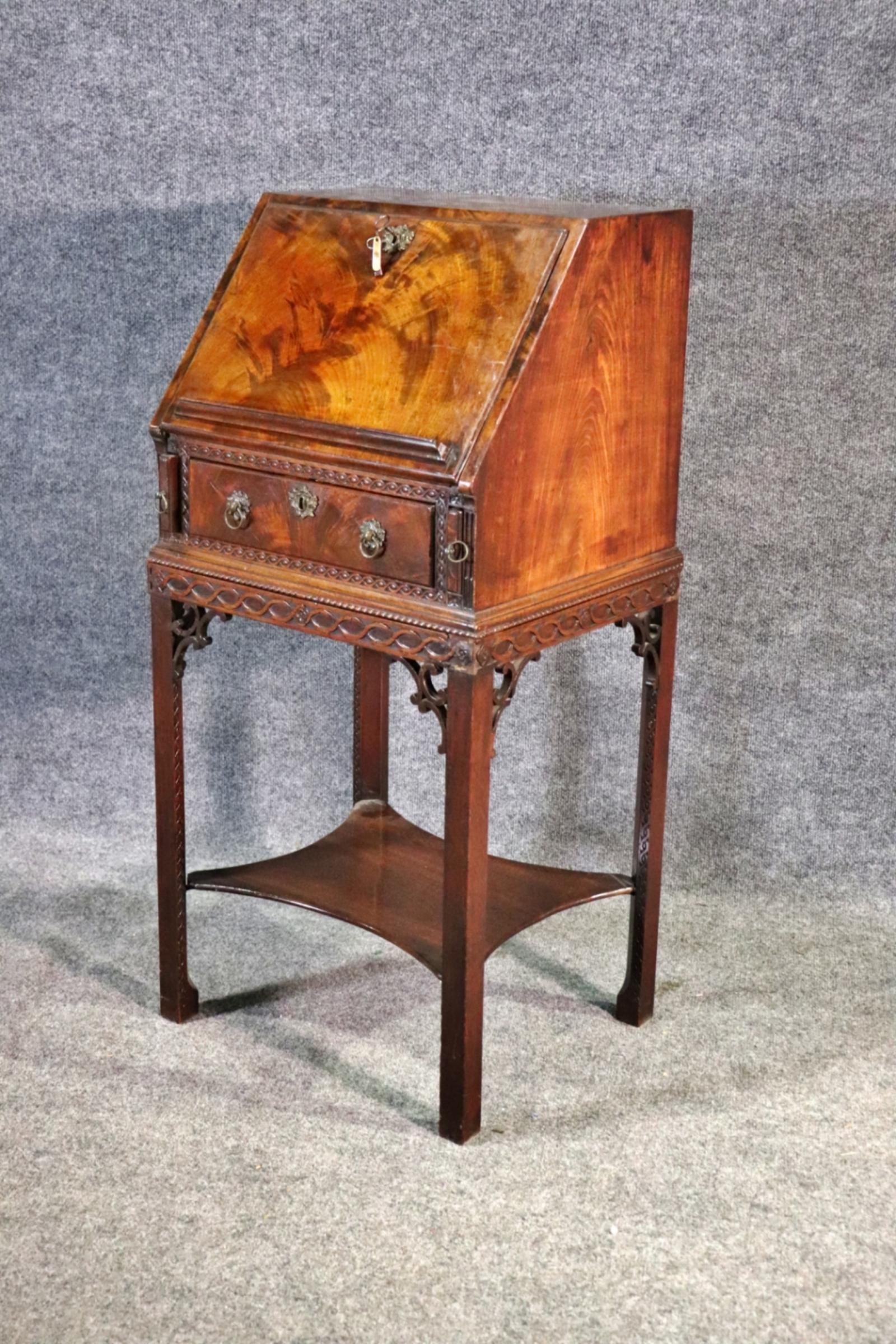 George III antique Burl walnut secretary 2 piece desk. Drop down door containing fitted interior and leather top. Carved base and bronze hardware. 1 dovetailed drawer. The stand raised on chamfered legs with pierced brackets and a shaped