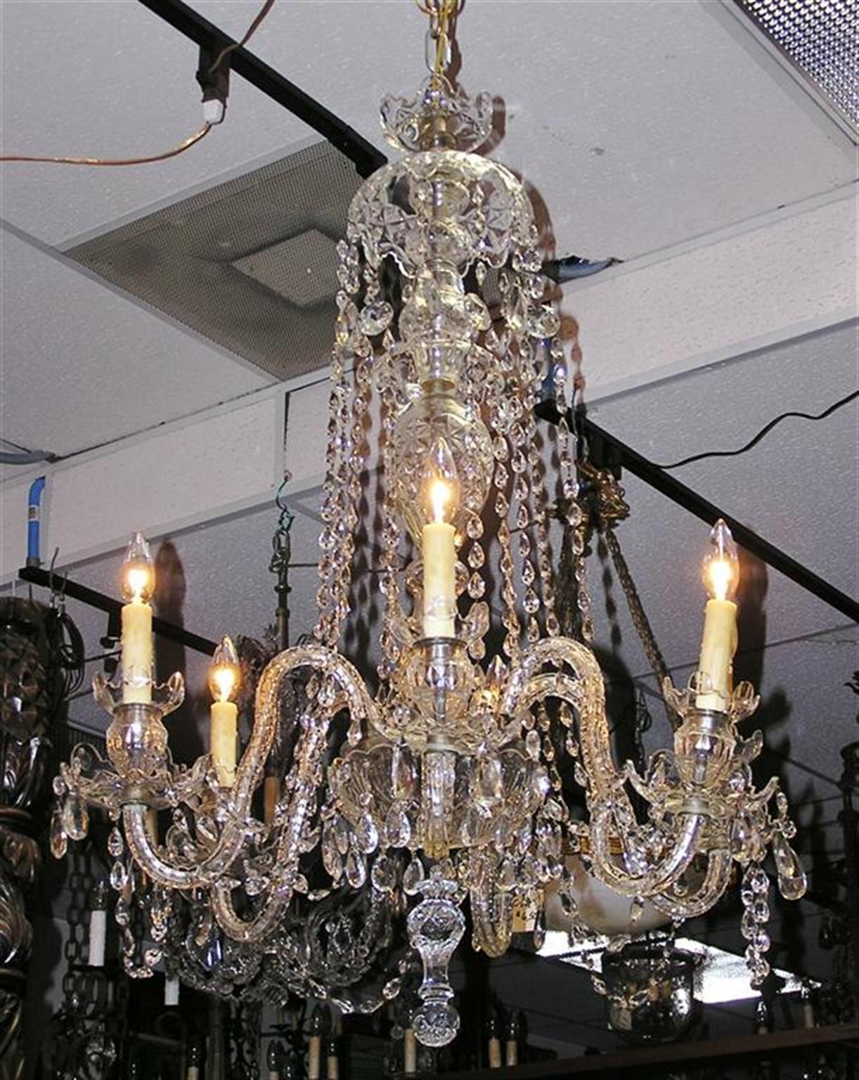 English cut crystal six light chandelier with a centered crystal bulbous column, scrolled etched crystal arms, and cascading crystal swags. Originally candle powered and has been electrified. 19th Century