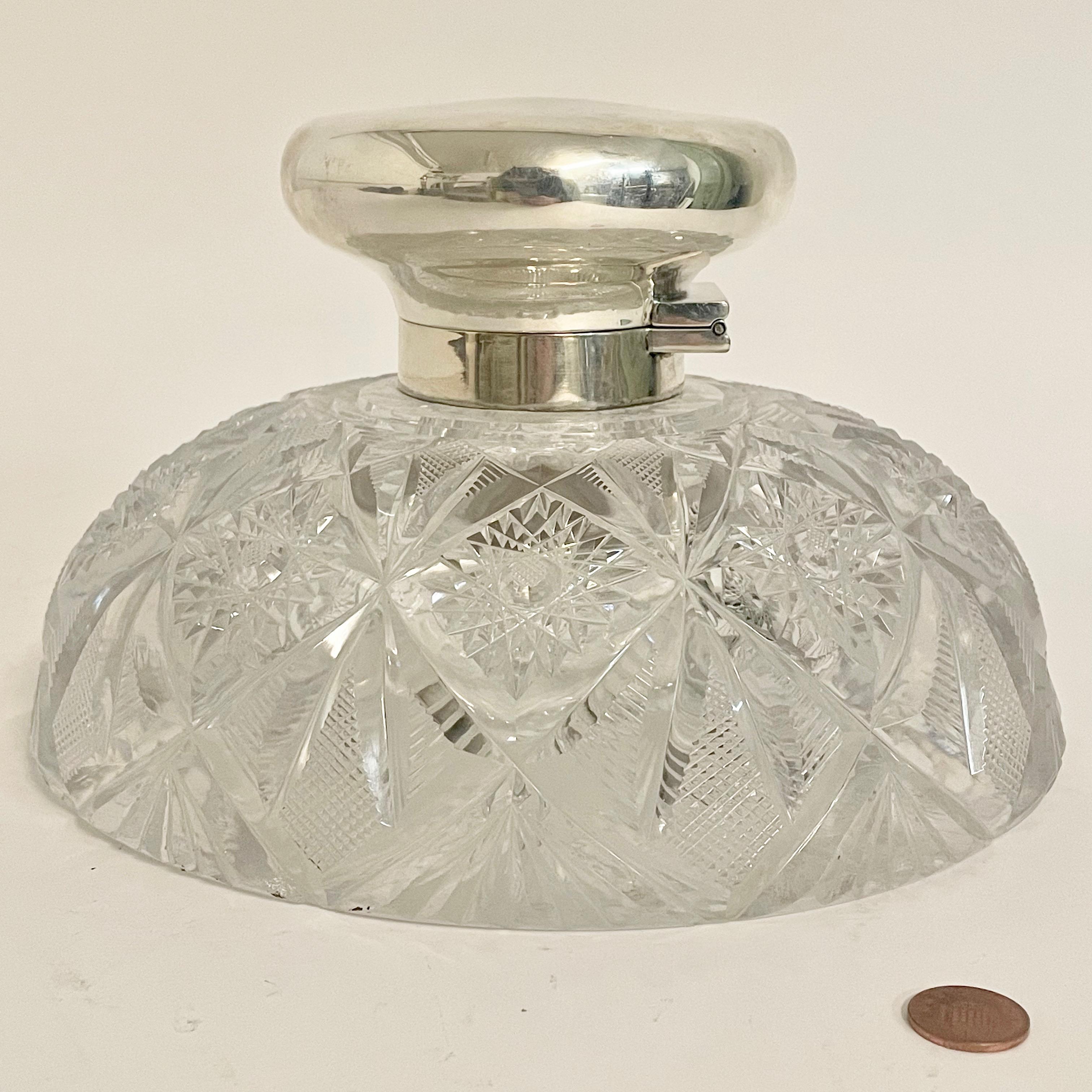 A very rare monumental inkwell, the finely cut crystal circular body with silver hinged lid. Hallmarks for Birmingham 1912 and makers stamp for Middleton & Heath.

 