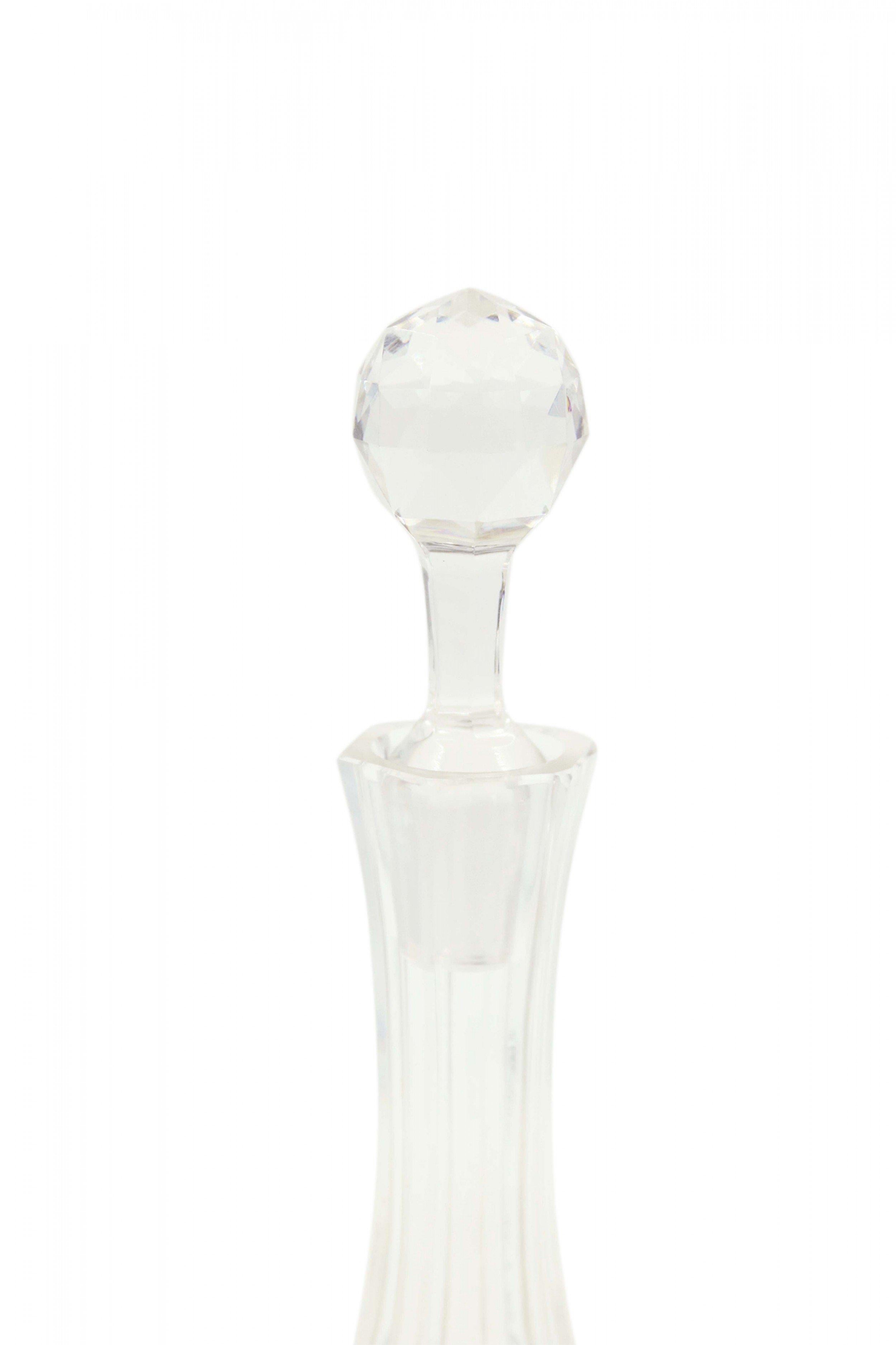 English Victorian style cut crystal decanter with a long neck and bulbous base with an adjoining faceted stopper.
  