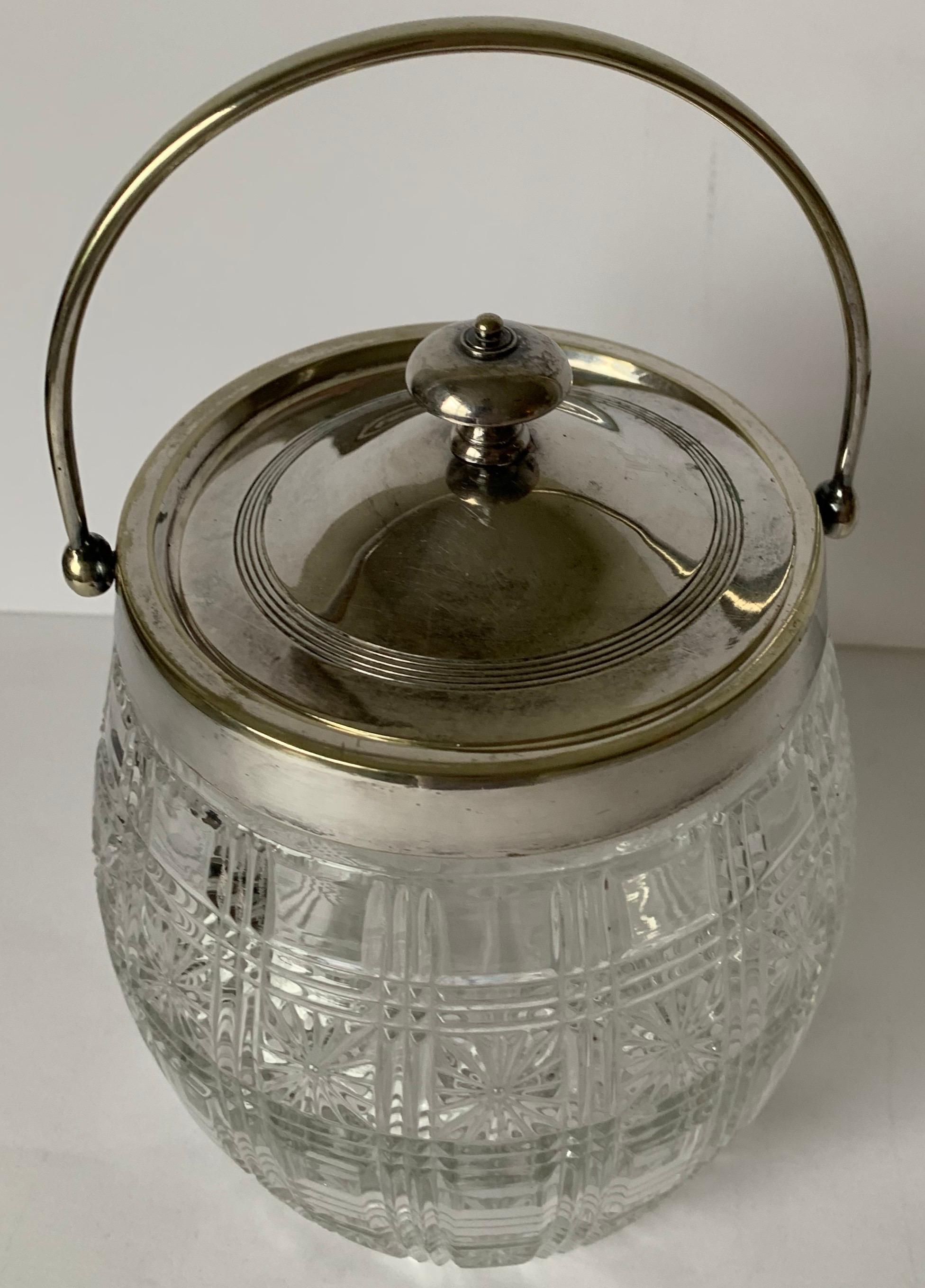 English cut glass and silver plate biscuit barrel. Clear cut glass. Silver plate lid and handle. No makers mark or signature.