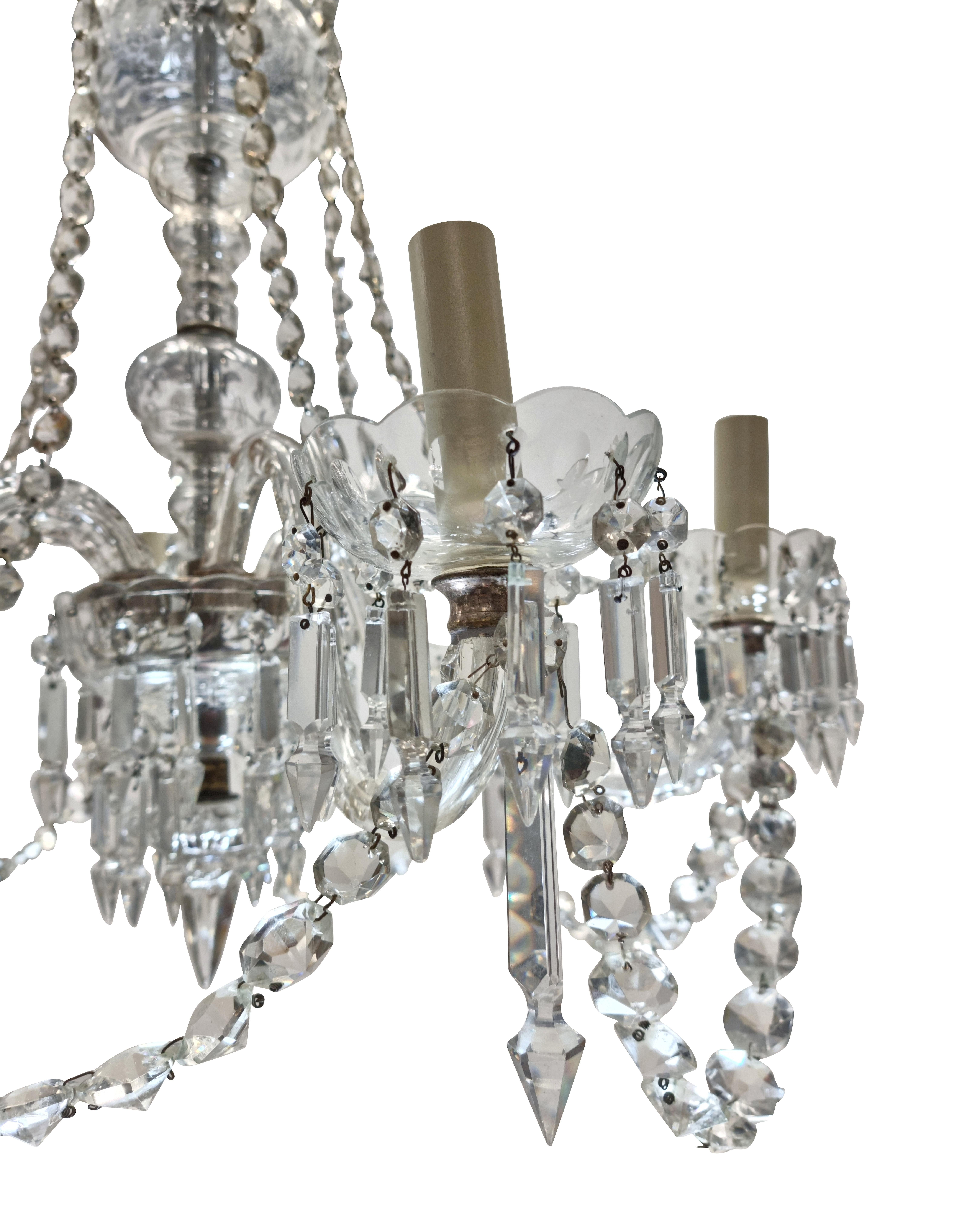 An English cut glass six arm chandelier of good quality, hung throughout with prisms, chains, pendants and swags.