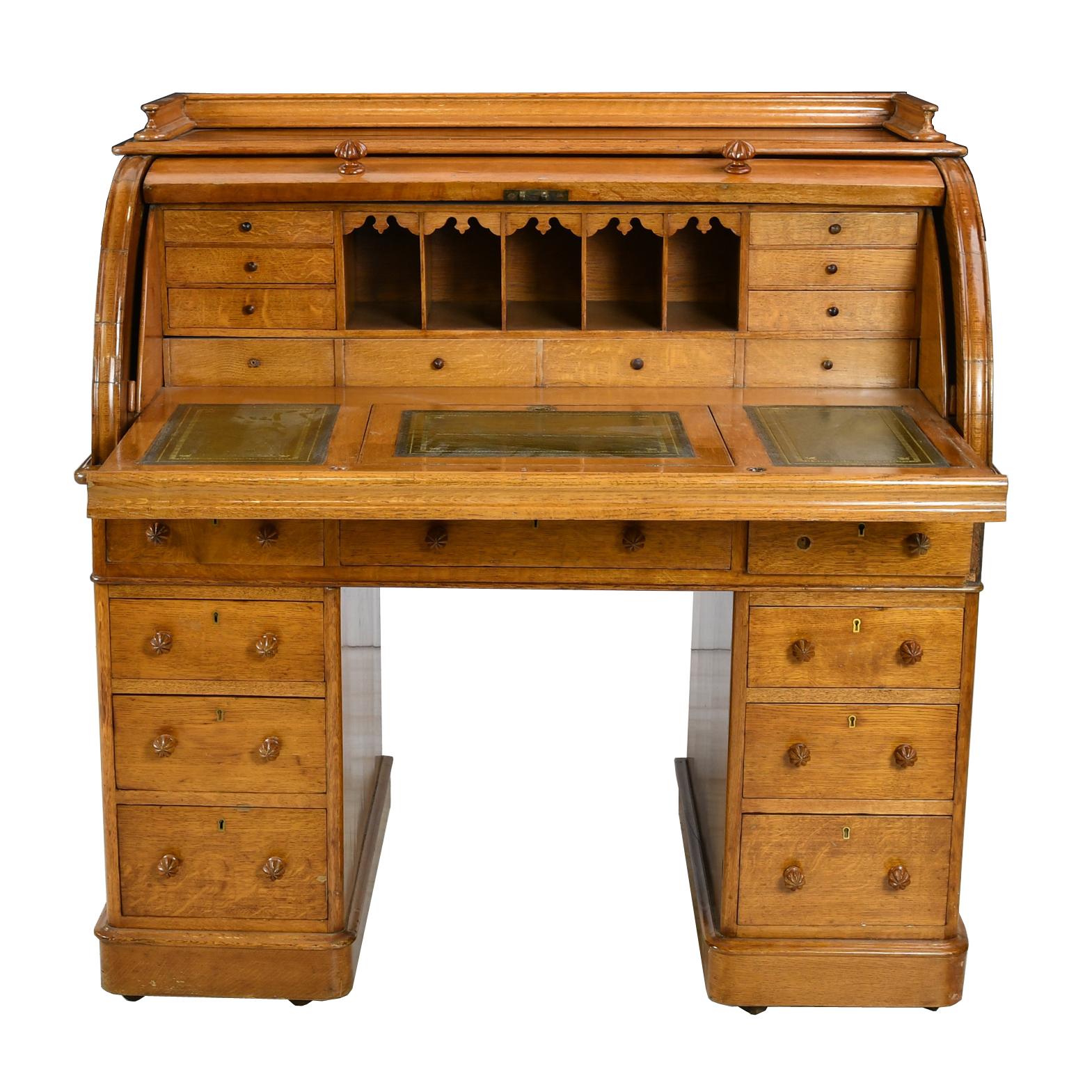 A more compact version of a classic model, this functional pedestal desk in light, golden oak is unusual in that it can float in a room and has the original casters, making it mobile too. Features a gallery above a cylinder top that opens to a desk