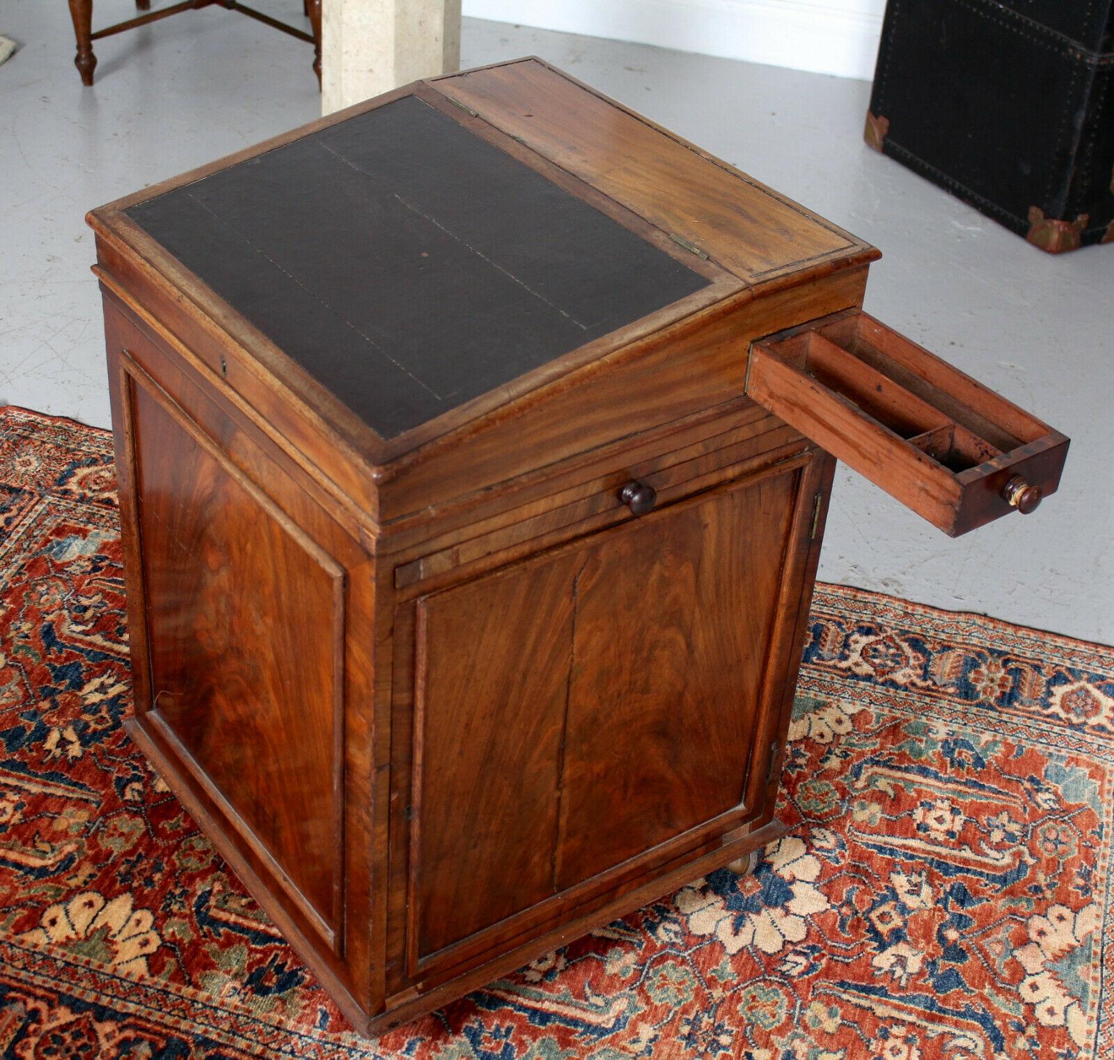 An impressive rare form mid-19th century davenport.

The polished flamed mahogany boasting a rich wild grain.

A gradual inclined fall flap - enclosed storage with hinged drawer to side above a brush slip and bead mounted cupboard door enclosed