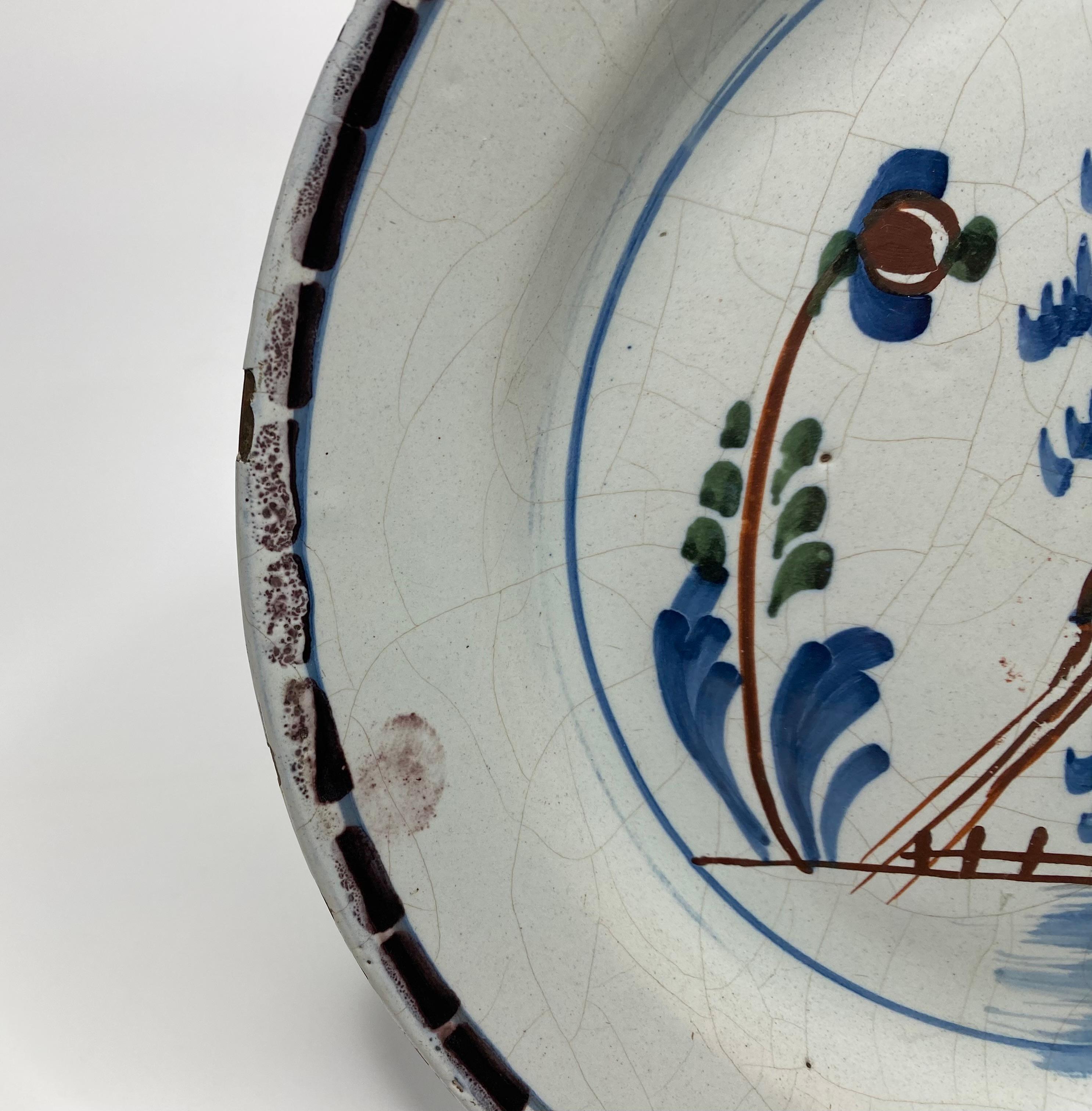 Fired English Delft pancake plate, Long tailed bird, London, c. 1750. For Sale