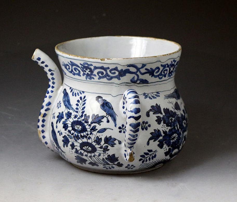 English delftware pottery blue and white chinoiserie decorated posset pot, late 17th century.

An English delftware pottery bulbous shaped posset pot with a flared rim profusely decorated in blue and white with eight birds, an insect, and foliage