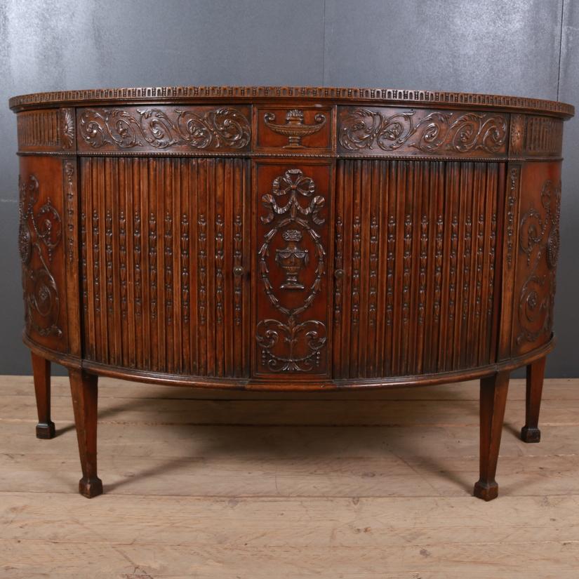 Pretty 18th century English carved mahogany demilune credenza, 1780

Dimensions:
54 inches (137 cms) wide
21.5 inches (55 cms) deep
34 inches (86 cms) high.

 