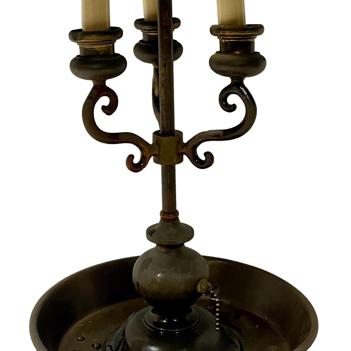 A circa 1940's English patinated bronze lamp with tole shade.

Measurements:
Height: 27.5