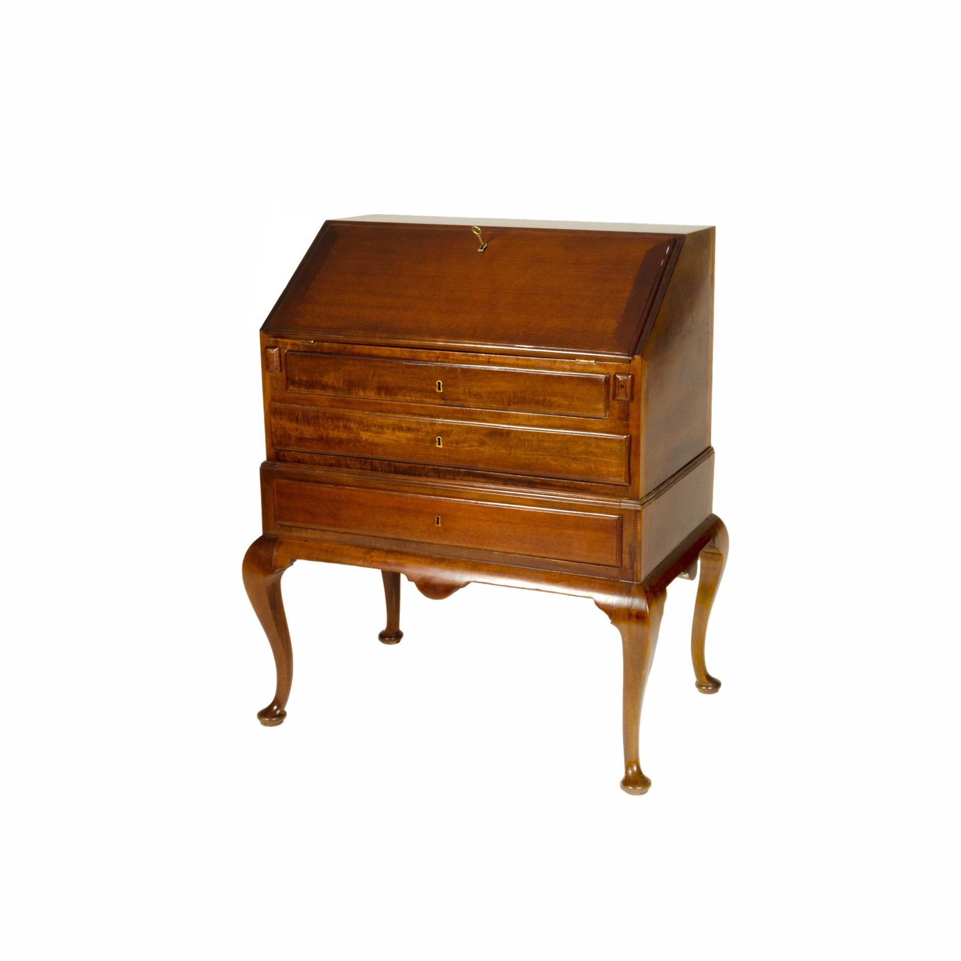  A Writing Desk with working metal hardware, a drop-front writing desk opening to an assortment of drawers and compartments, four dovetailed drawers. 
The interior has multiple pigeon holes and shaped interior drawers, pilaster drawers, fan carving,